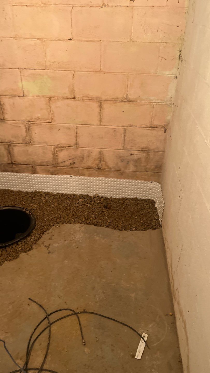 Interior drain tile system installation by ACE Waterproofing & Basement Solutions