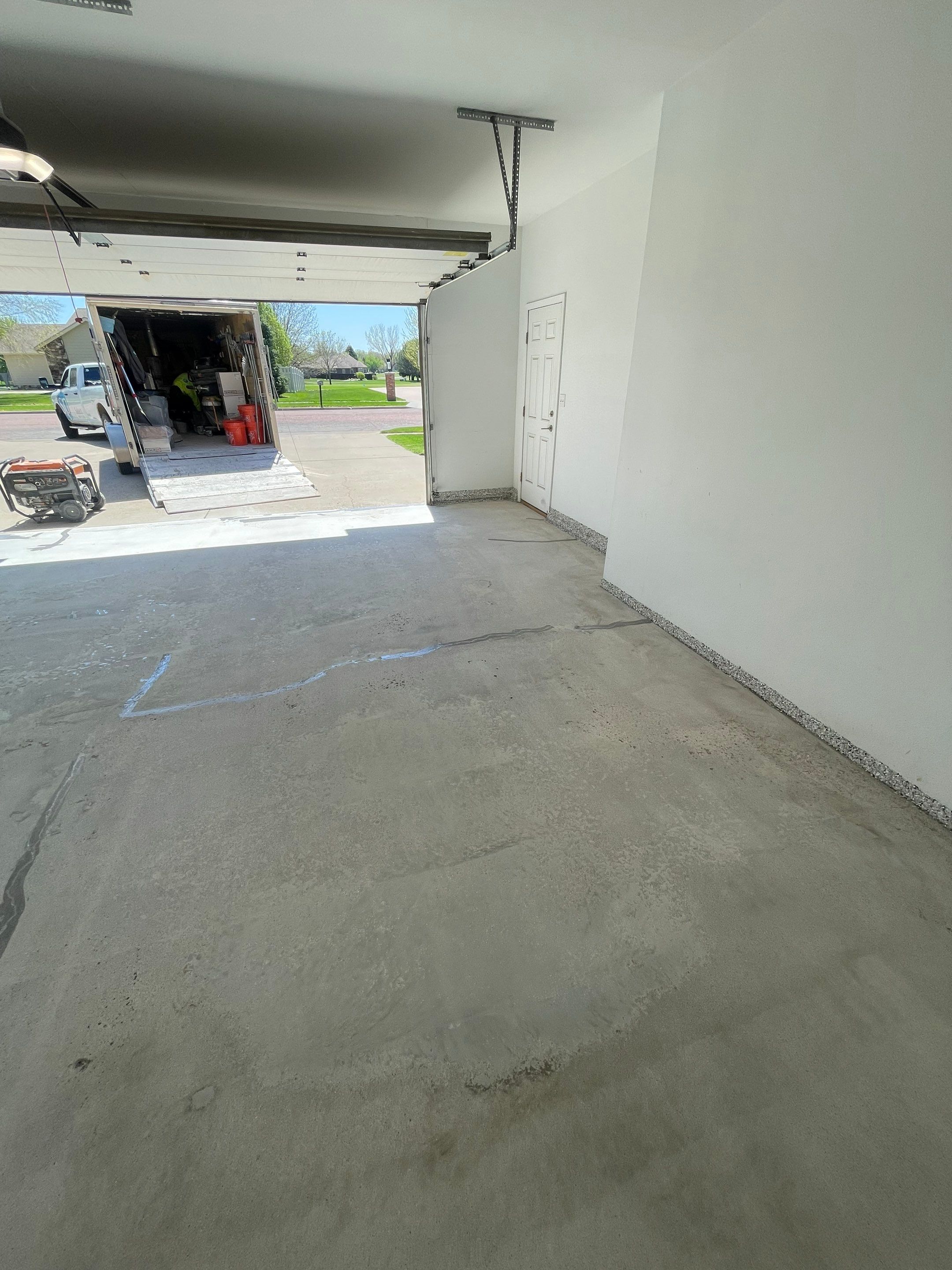 Yankton Garage Floor Restoration with Gray Speckled Epoxy Coating by Select Painting, Coatings & Garage Cabinets