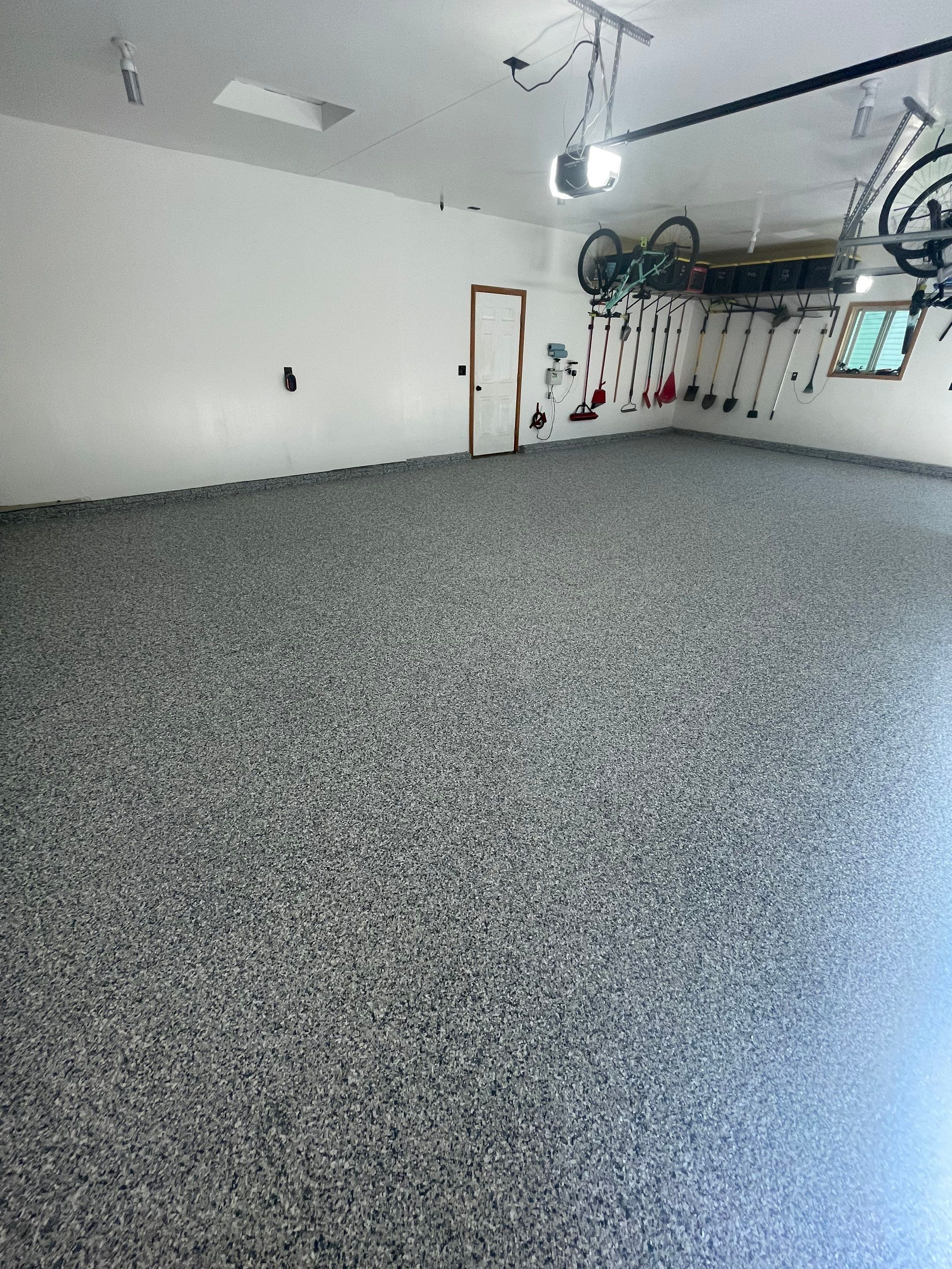 Tidal Wave Flake Garage Floor Installation in Sioux Falls by Select Painting, Coatings & Garage Cabinets