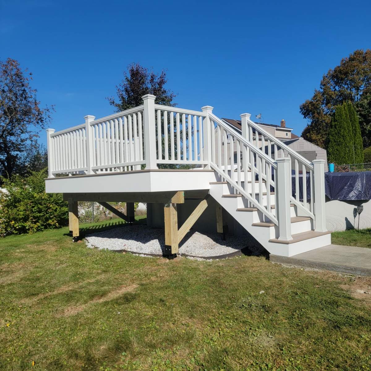 New pool deck and main deck resurface using Trex Transcend Rope Swing boards, White railing and Lattice by DiGiorgi Roofing and Siding Inc