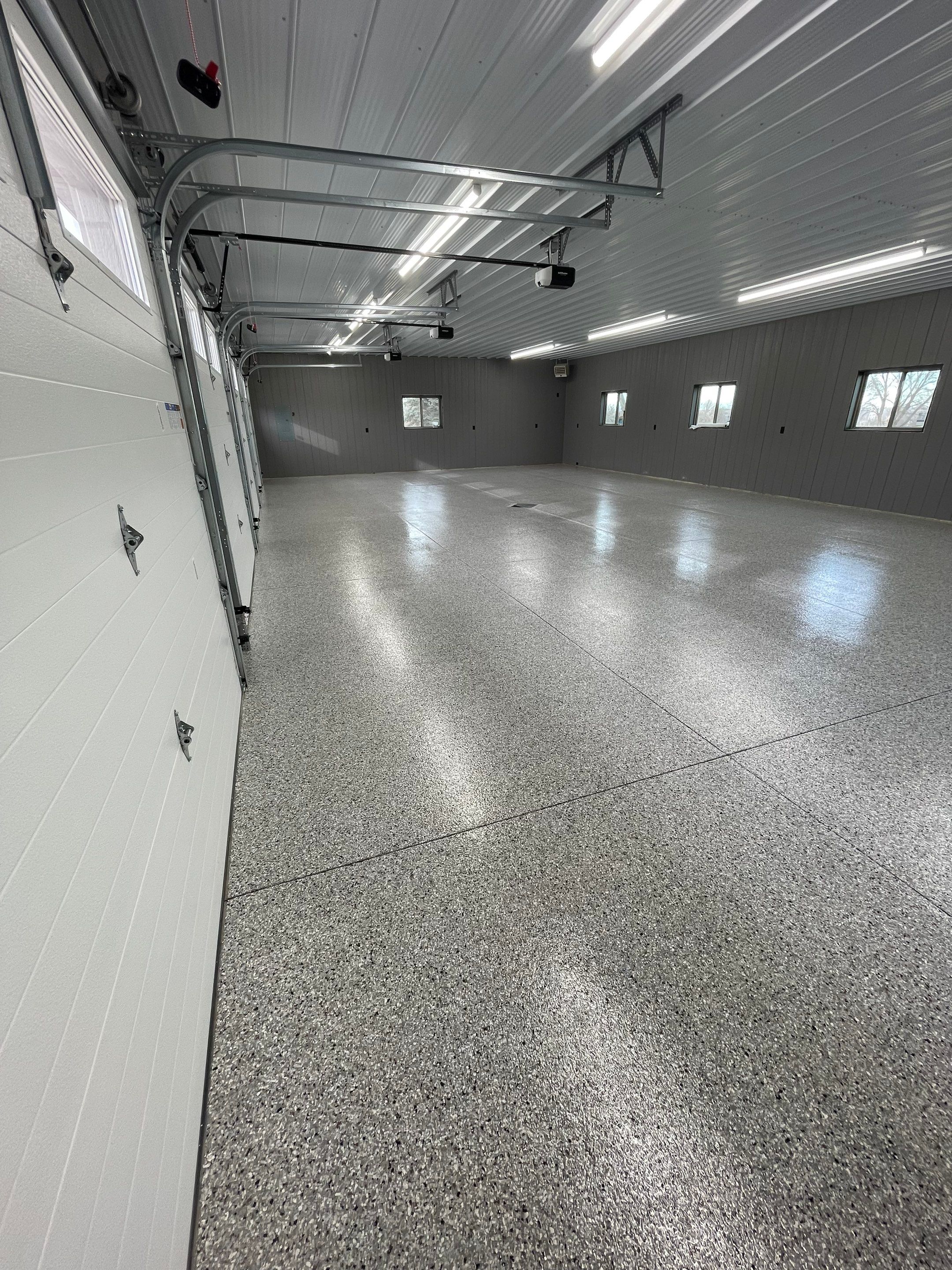Speckled Epoxy Floor Coating for Large Shop in Rock Valley by Select Painting, Coatings & Garage Cabinets