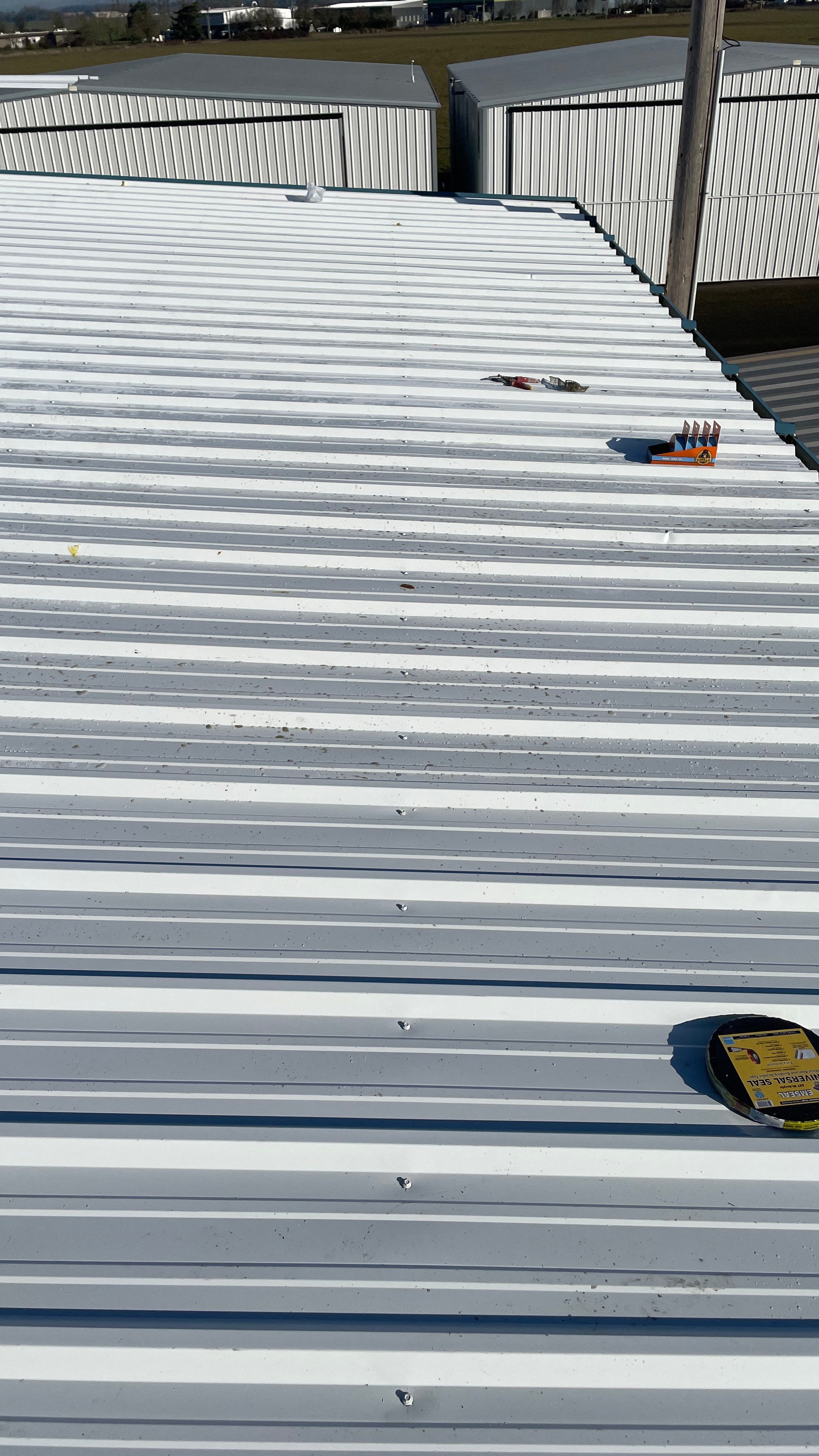 Airport Hanger Metal Roof Replacement and Insulation by Villegas Remodeling, LLC