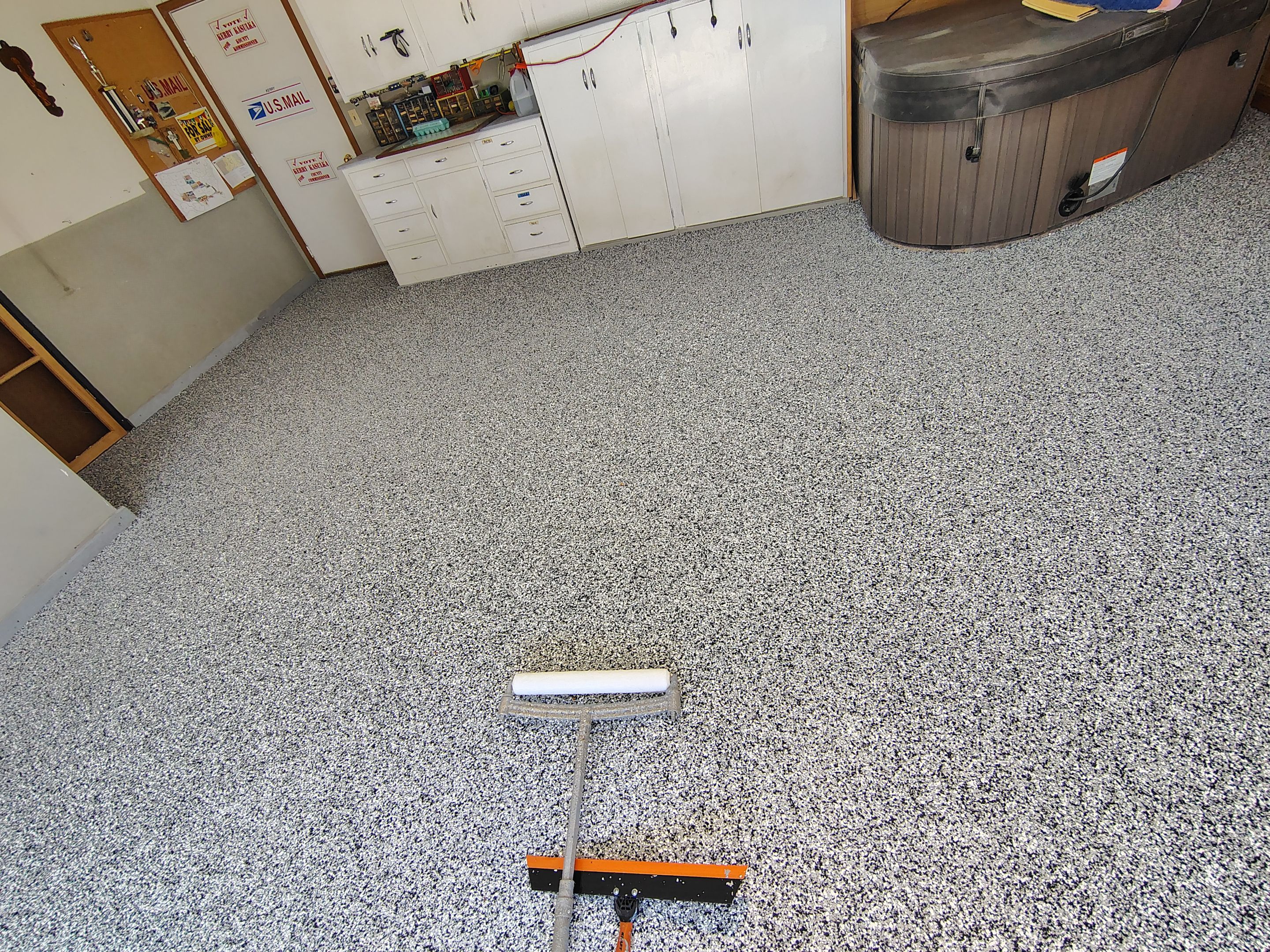 Domino Flake Garage Floor Coating Installation in Sioux Falls by Select Painting, Coatings & Garage Cabinets