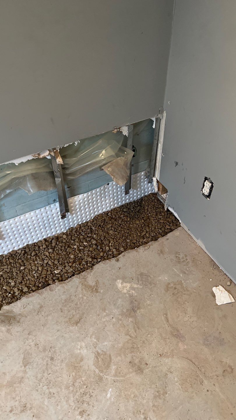 Interior drain tile system installation by ACE Waterproofing & Basement Solutions