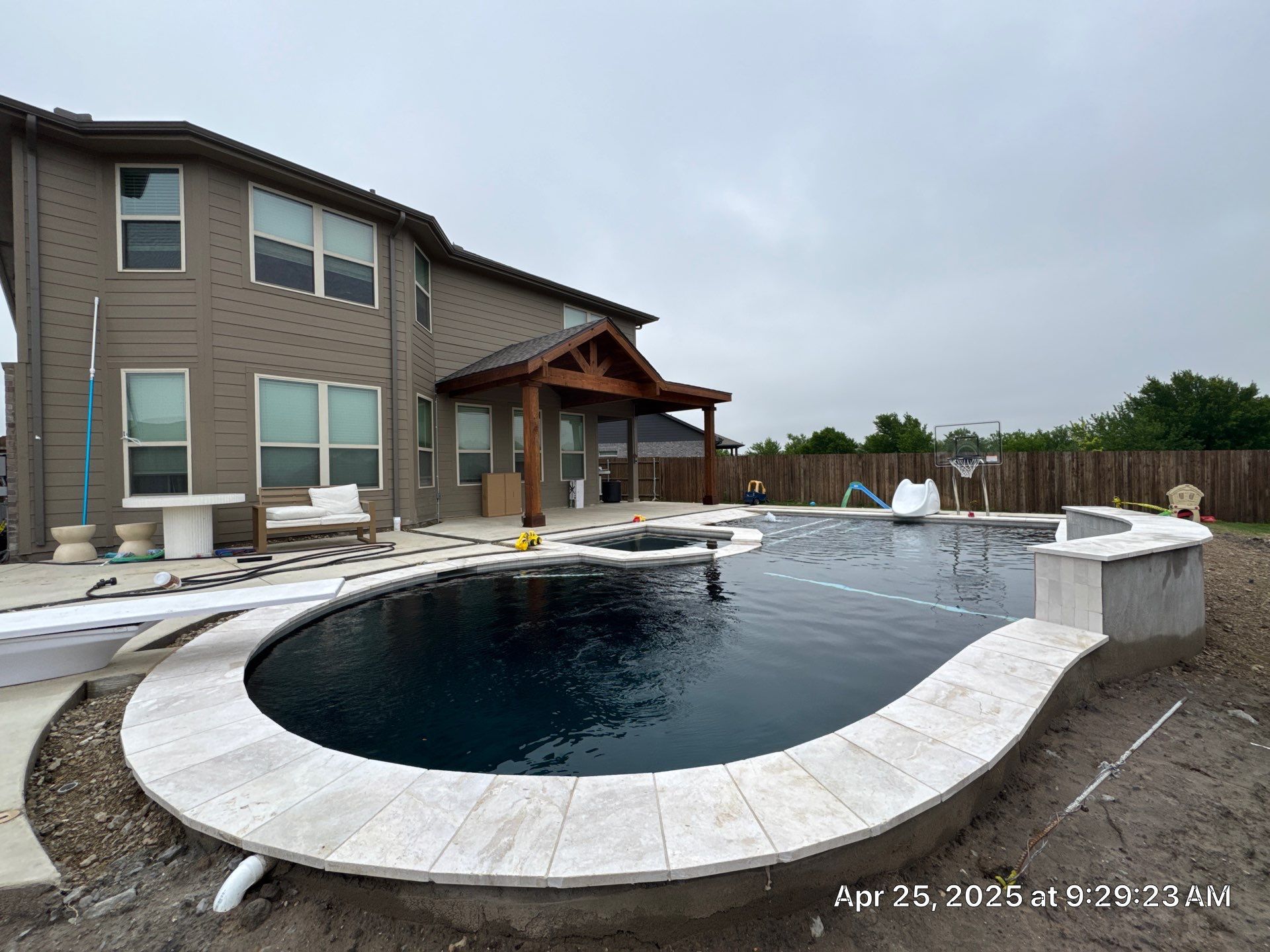 Geometric Pool with Spillover Spa and Dark Interior by Pinnacle Pools and Spas - DFW