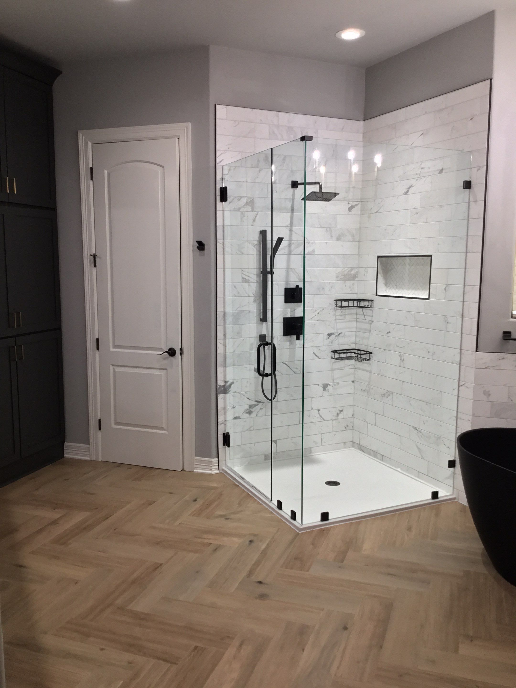 Spring Bathroom Remodel with Black Free-Standing Tub and Walk-In Shower by Legacy Bath and Kitchen