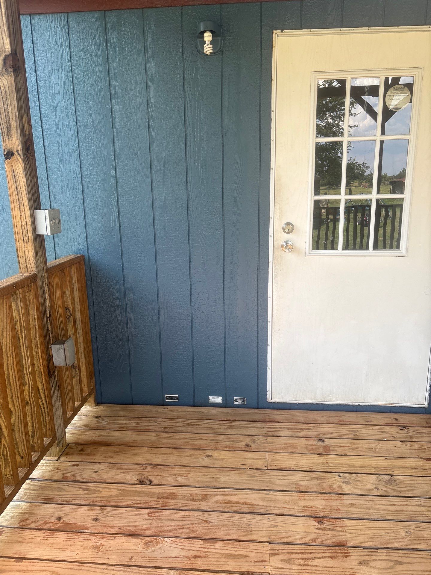 Exterior Painting in Fruitvale, TX | Wood Porch & Home in Deep Navy Blue by Quality Coats Painting