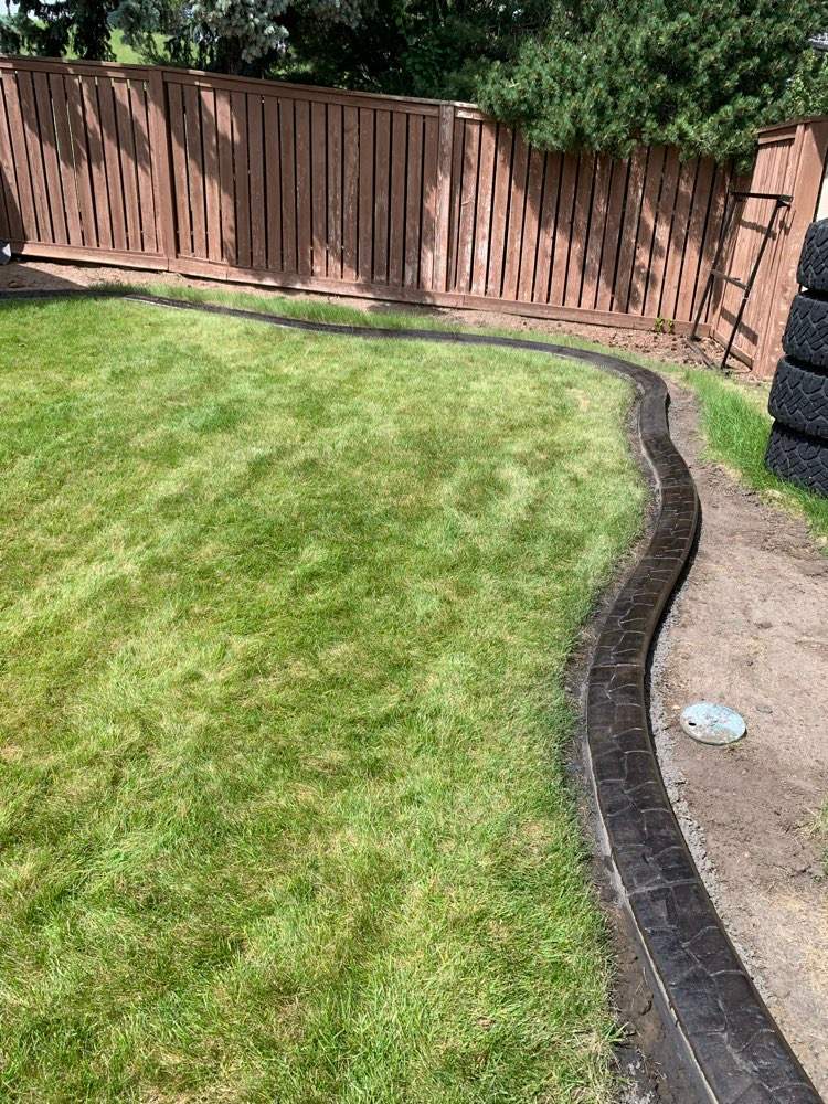 Decorative Stamped Concrete Garden Border Installation in Medicine Hat by Pump it Up Concrete Jacking
