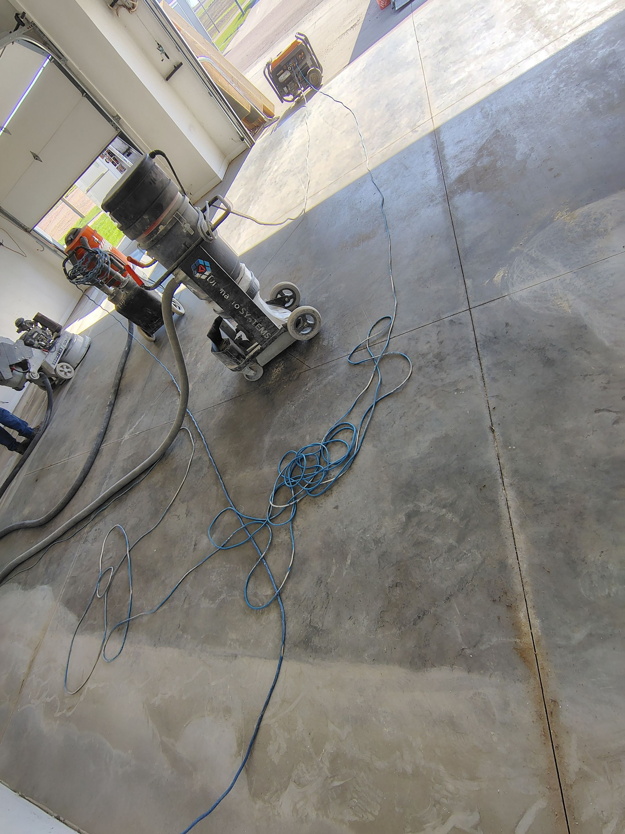 Speckled Polyaspartic Garage Floor Coating Installation in Dell Rapids by Select Painting, Coatings & Garage Cabinets
