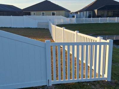 Vinyl Fence Installation using 6Ft White Vinyl Privacy Fence with a 4Ft White Clearwater Picket Fence