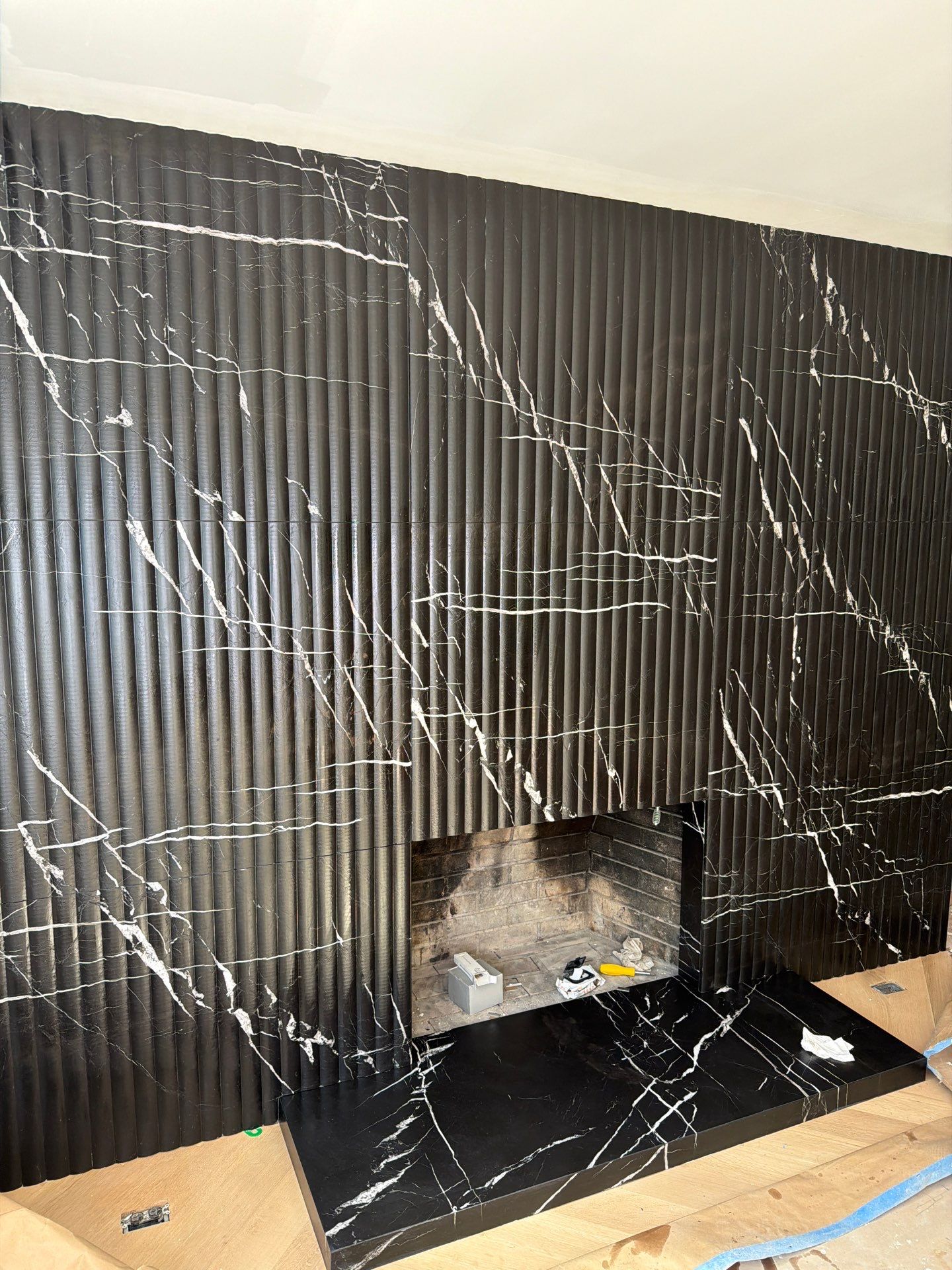 Full-Height Fluted Marble Fireplace Wall by NC Stone And Tiles