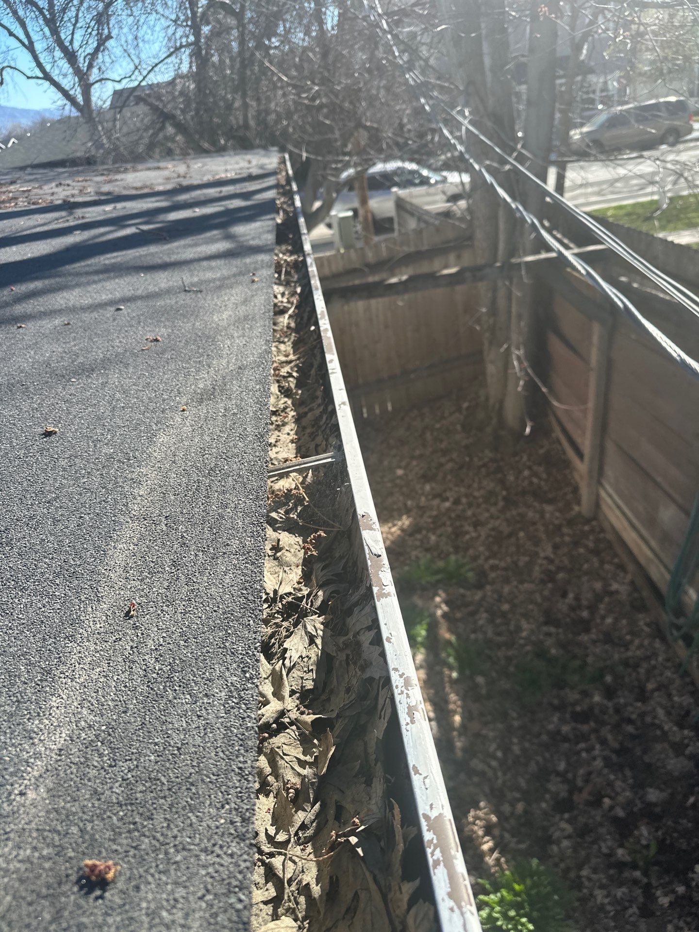 Commercial gutter cleaning Idaho before photo with filled gutters