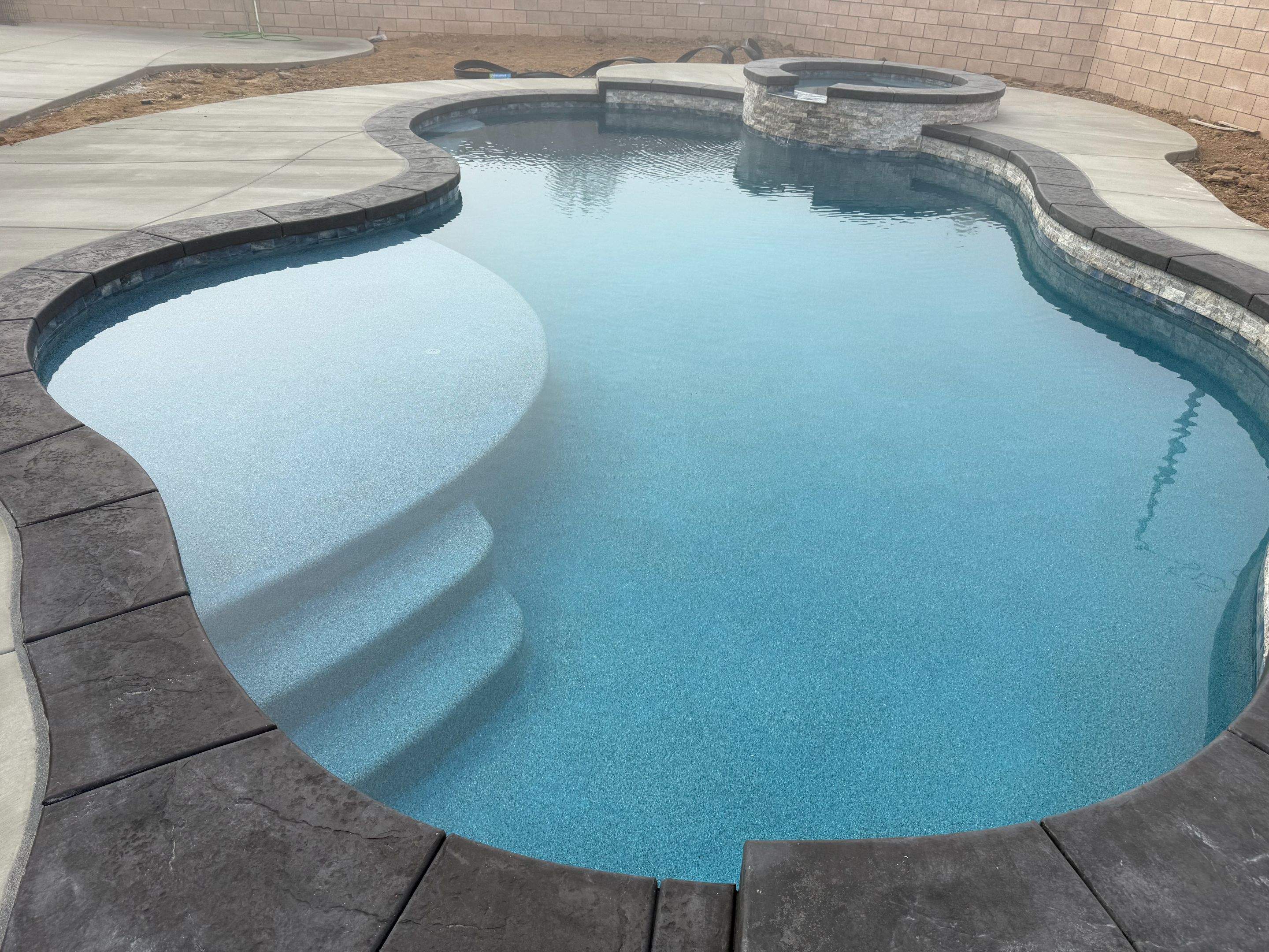 Freeform pool and spa pip coping by Premier Pools and Spas Temecula