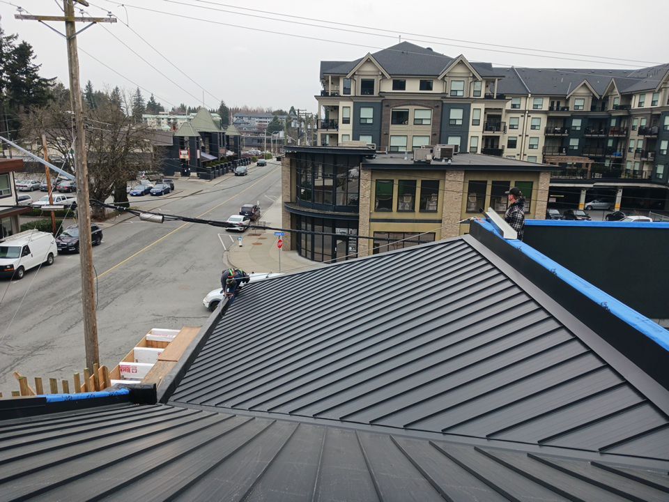 Commercial Roofing Installation using 12" Prolok metal and hidden gutters! by Top Notch Roofing Inc