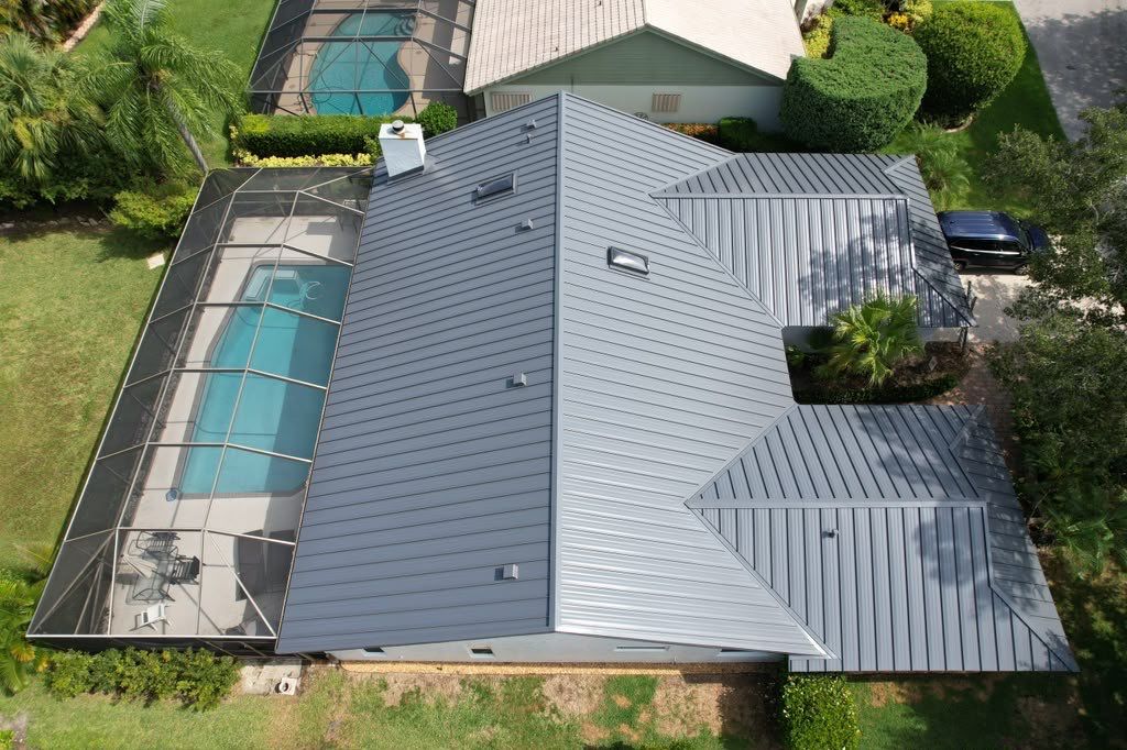 Standing Seam Metal Charcoal Grey Roof Replacement and Skylight Installation in Jupiter by Art's Roofing & Construction