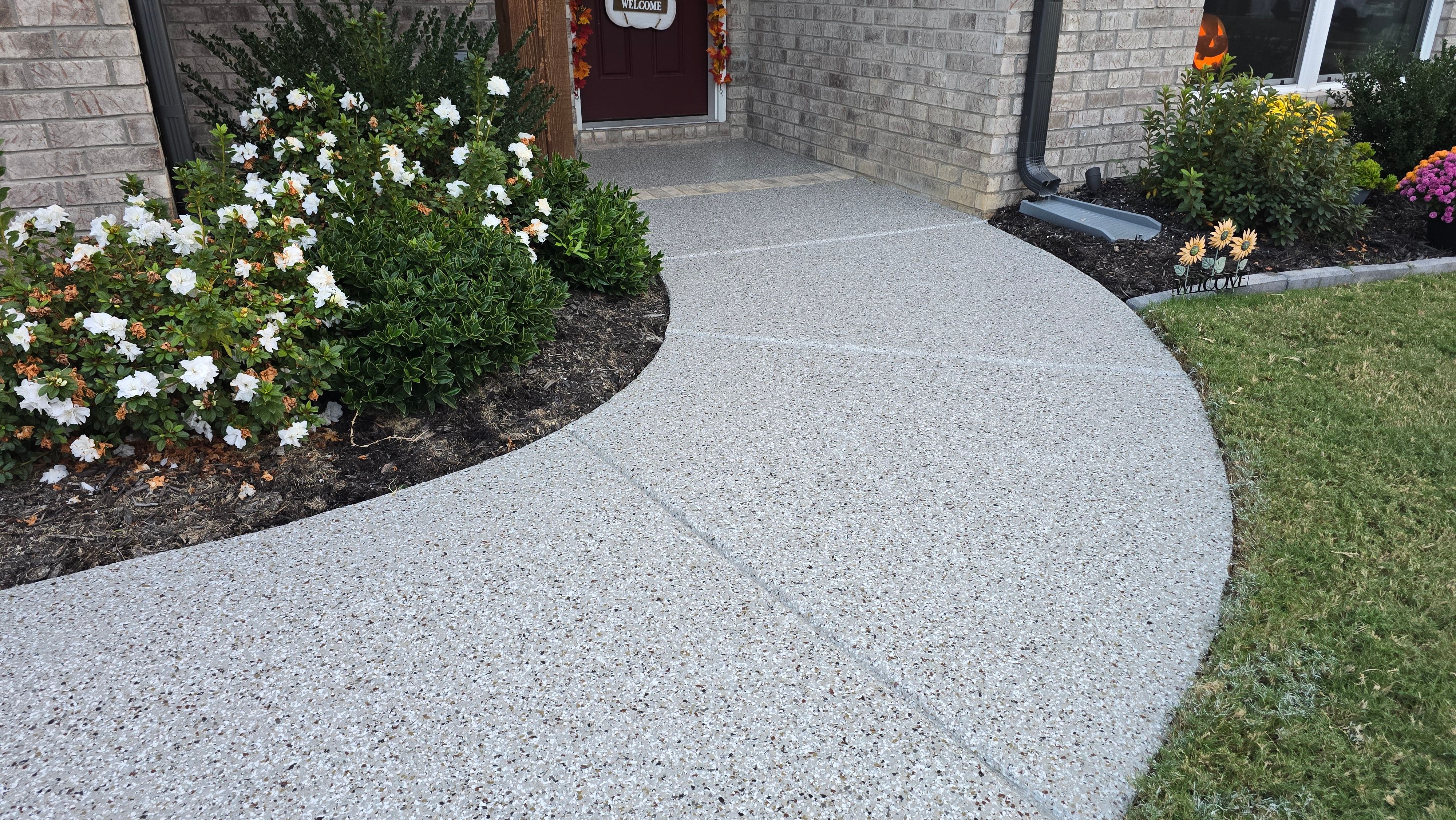 Sidewalk, Porch, and Back Patio Using Creekbed and Nordic Green by Elite Floor Solutions