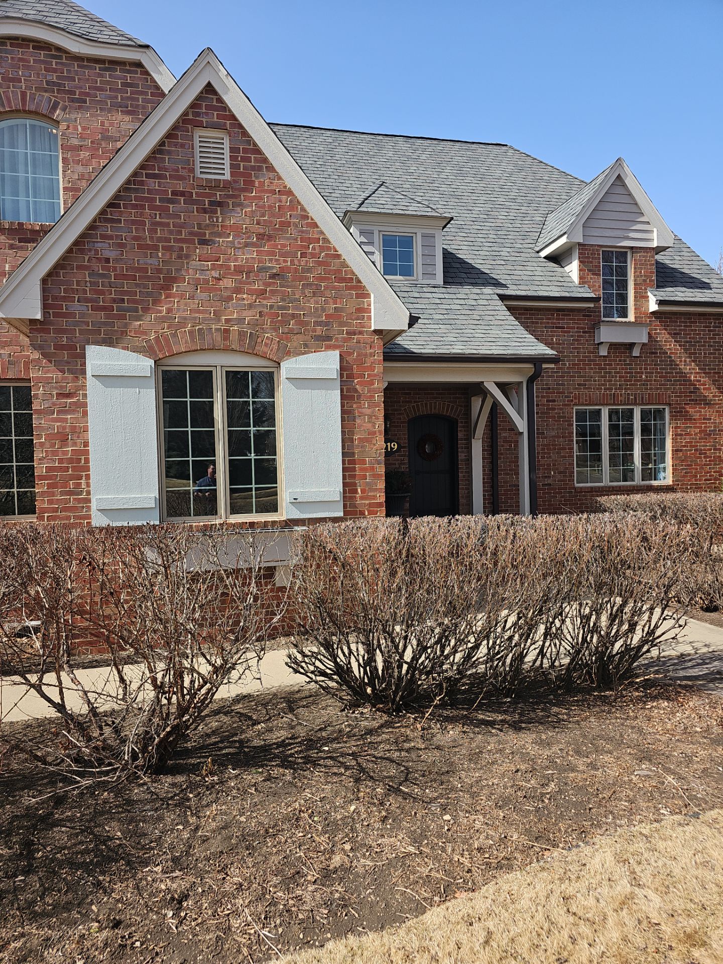 Residential Exterior Brick Painting and Limewash Refresh in Sioux Falls by Select Painting, Coatings & Garage Cabinets