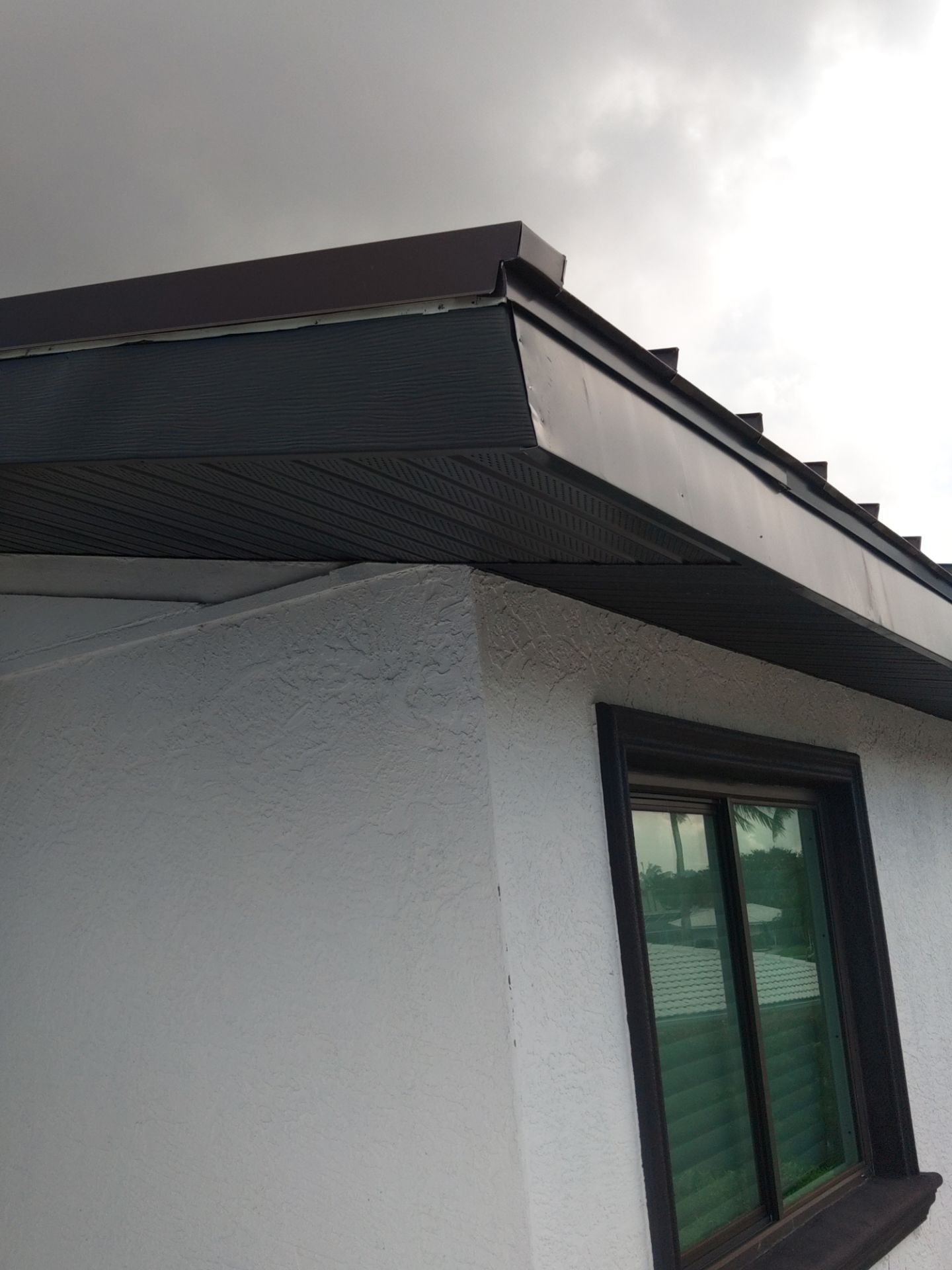 Black Seamless Gutters and Downspouts in Siesta Key FL by Gutter Professors