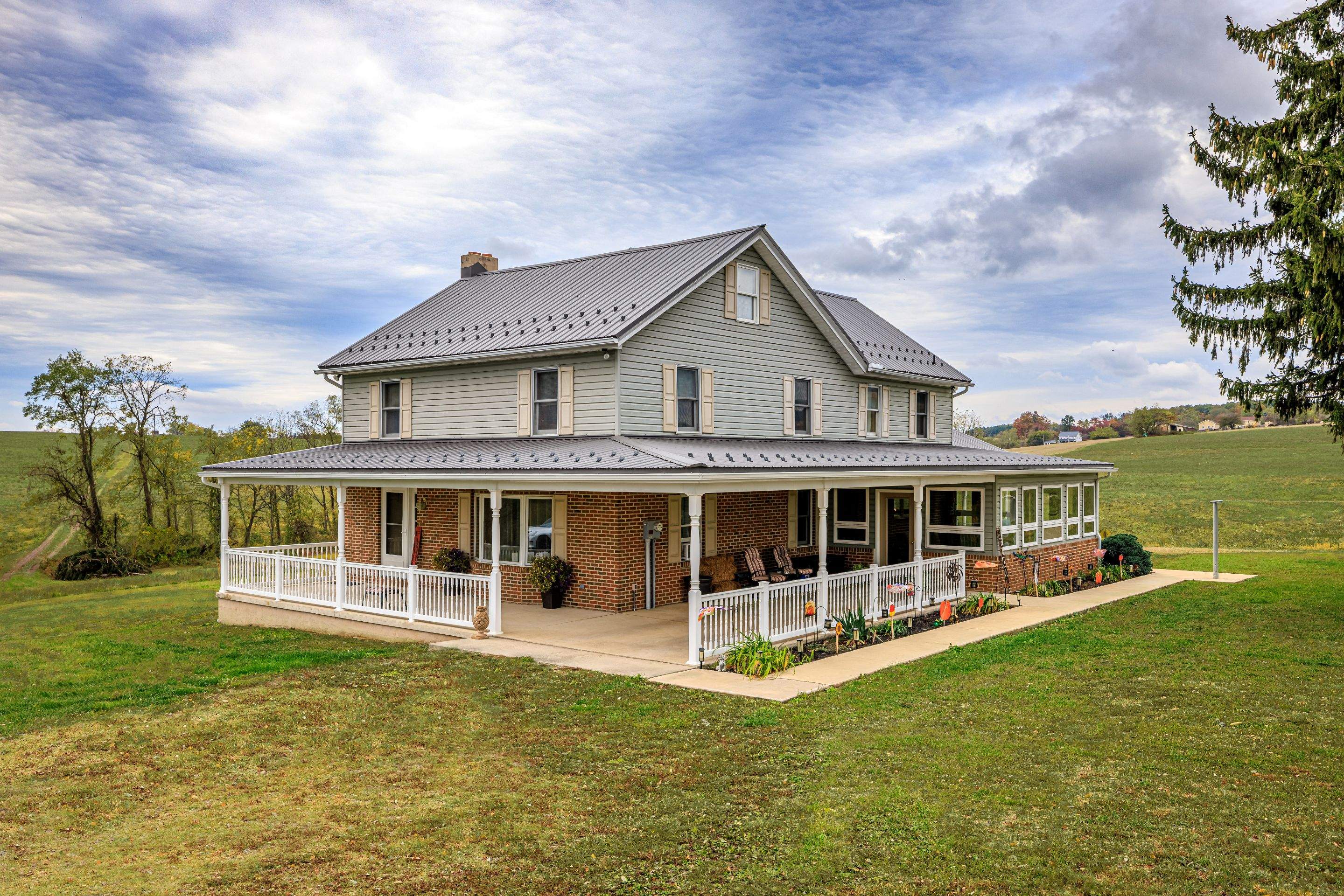 Classic Farmhouse With Textured Charcoal Metal Roof by Esh Builders