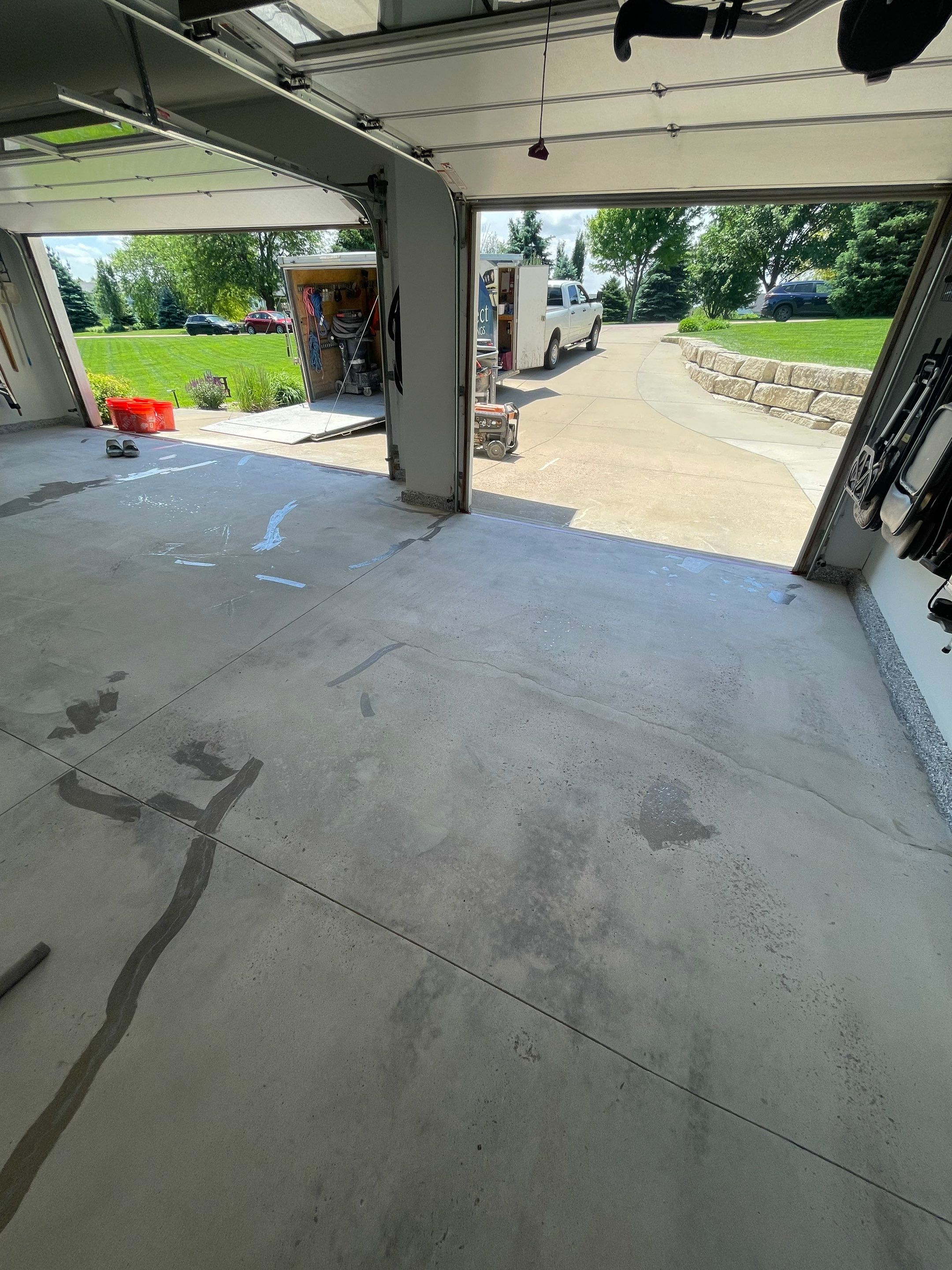 Feather Grey Garage Floor Coating Installation in Sioux Falls by Select Painting, Coatings & Garage Cabinets