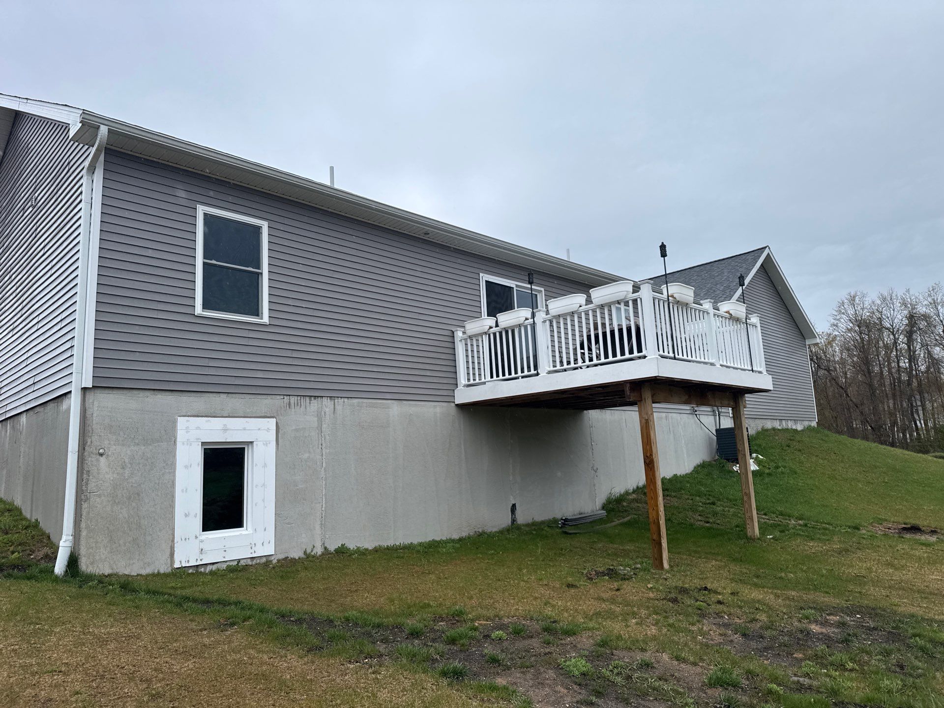 Sunesta Retractable Awning Installation Over Petoskey Home Deck by Rainbow Seamless Systems