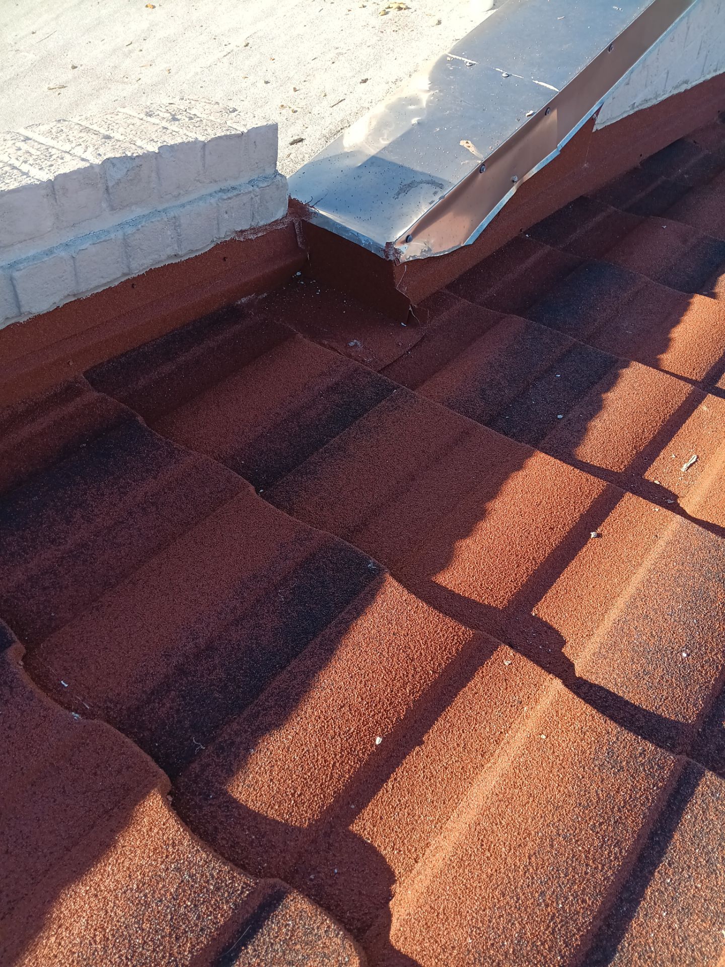 Off with the Tile and on with the TILCOR stone coated metal.  by Bayfront Roofing and Construction