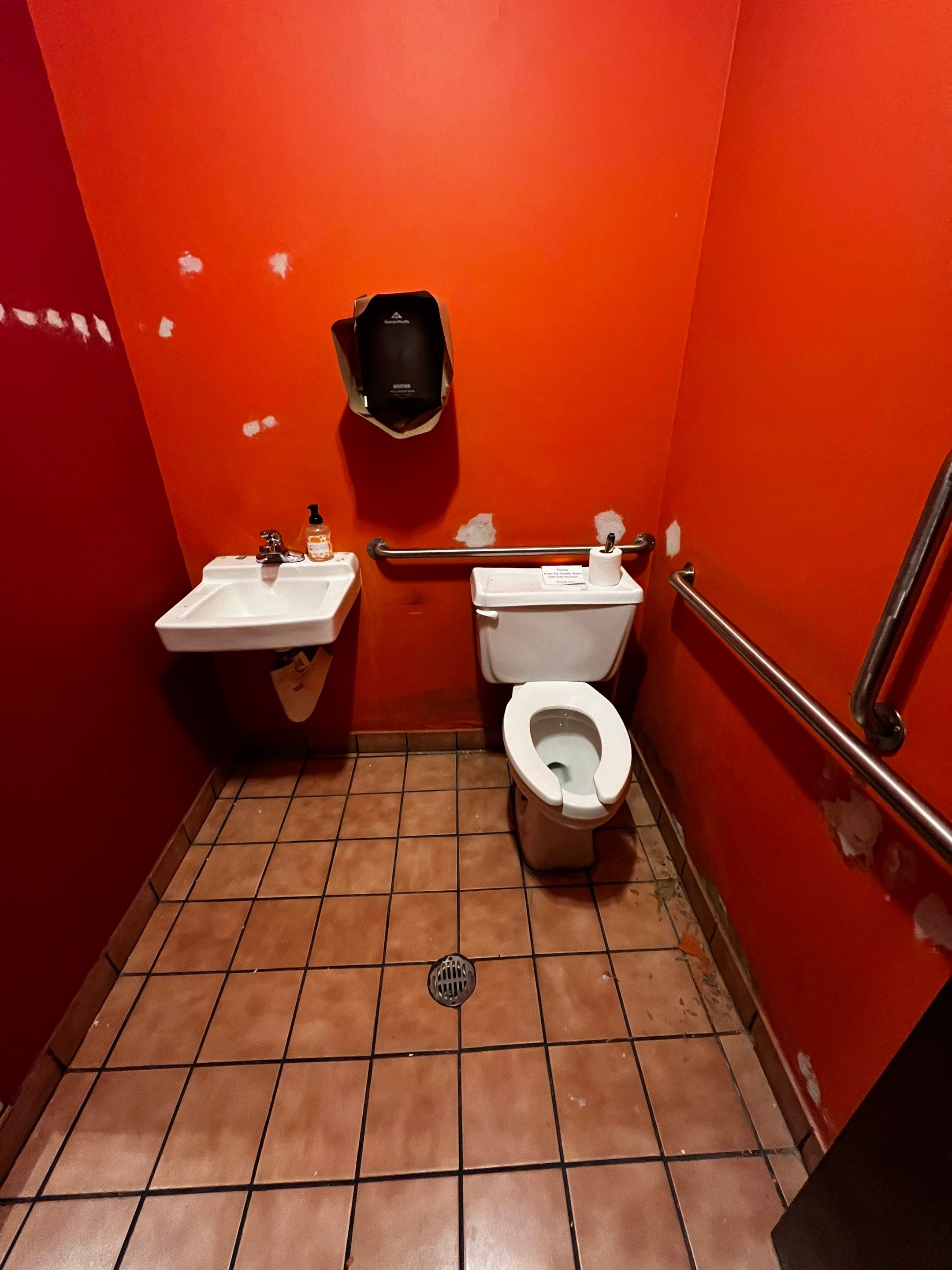 Commercial Restaurant Restroom Renovation Featuring Patterned Wallpaper in Smyrna by Swift Home Renovations