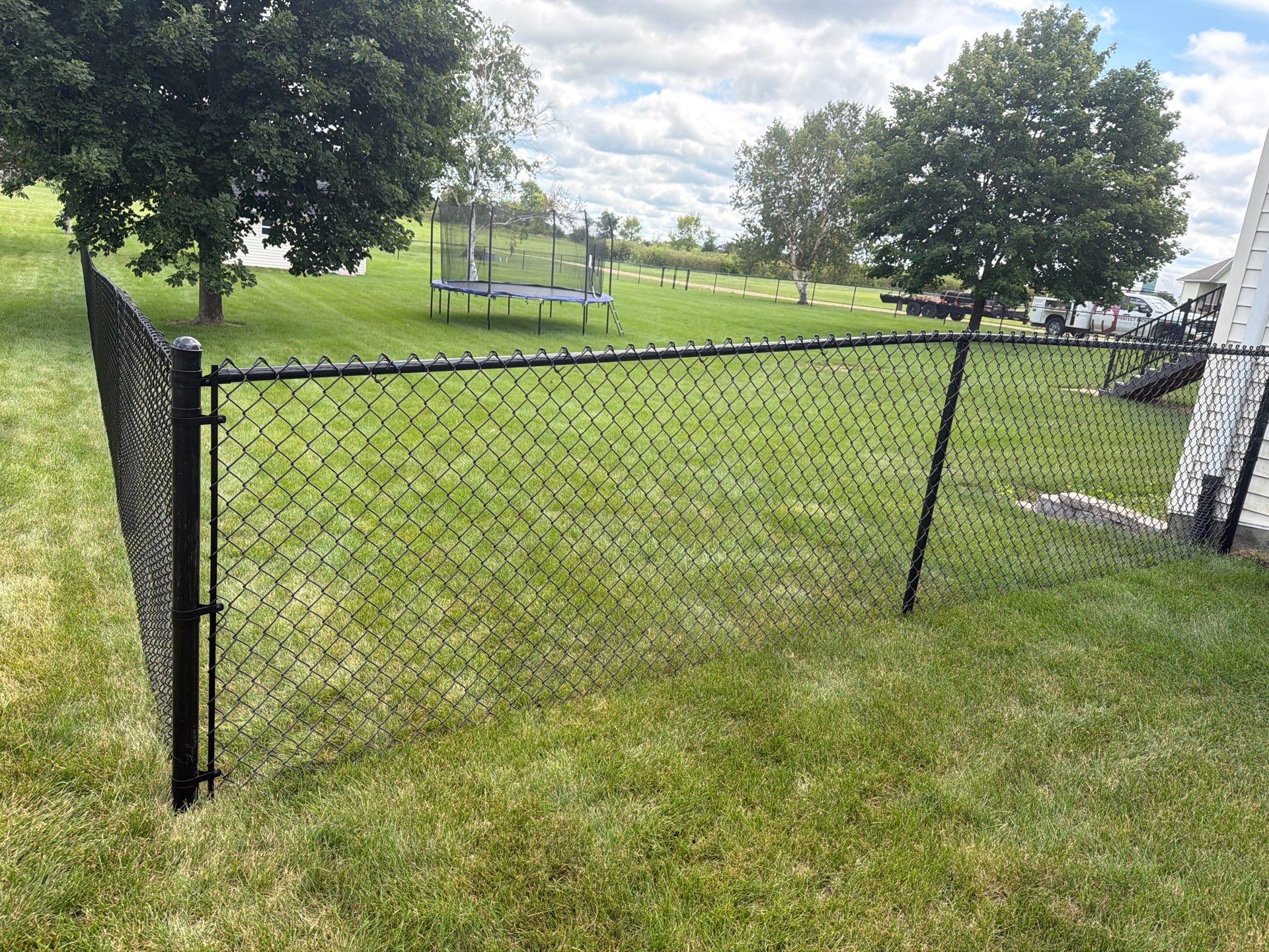 Black Vinyl-Coated Chain Link Fence Installation in Fairbank by Perfect Picket Fence and Stain