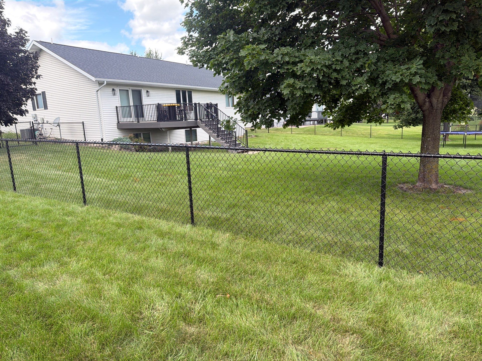Black Vinyl-Coated Chain Link Fence Installation in Fairbank by Perfect Picket Fence and Stain