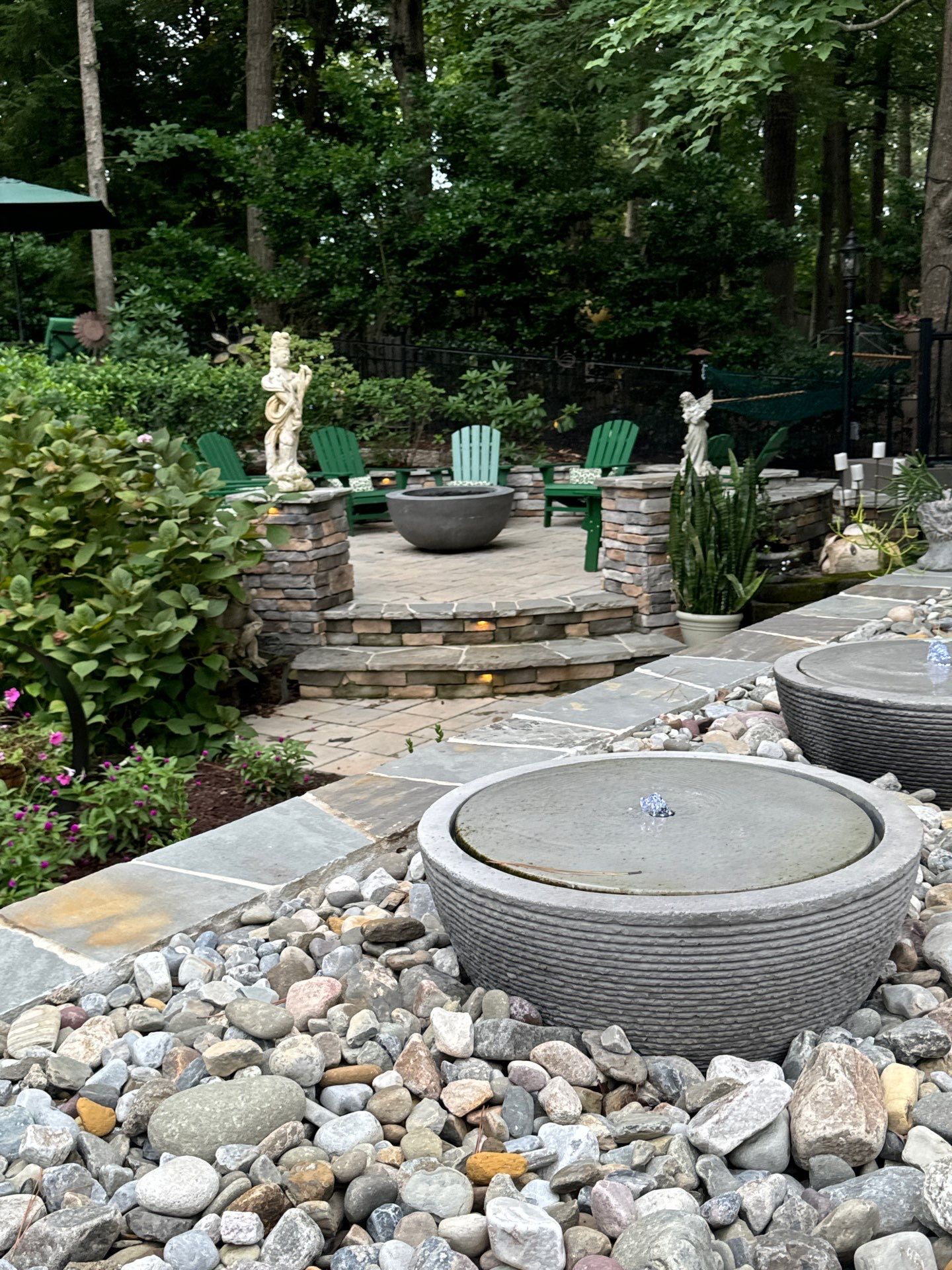 New Deck, Stone Fountain Feature, Circle Stone Sitting Area with Fireplace by The Remodeling Company