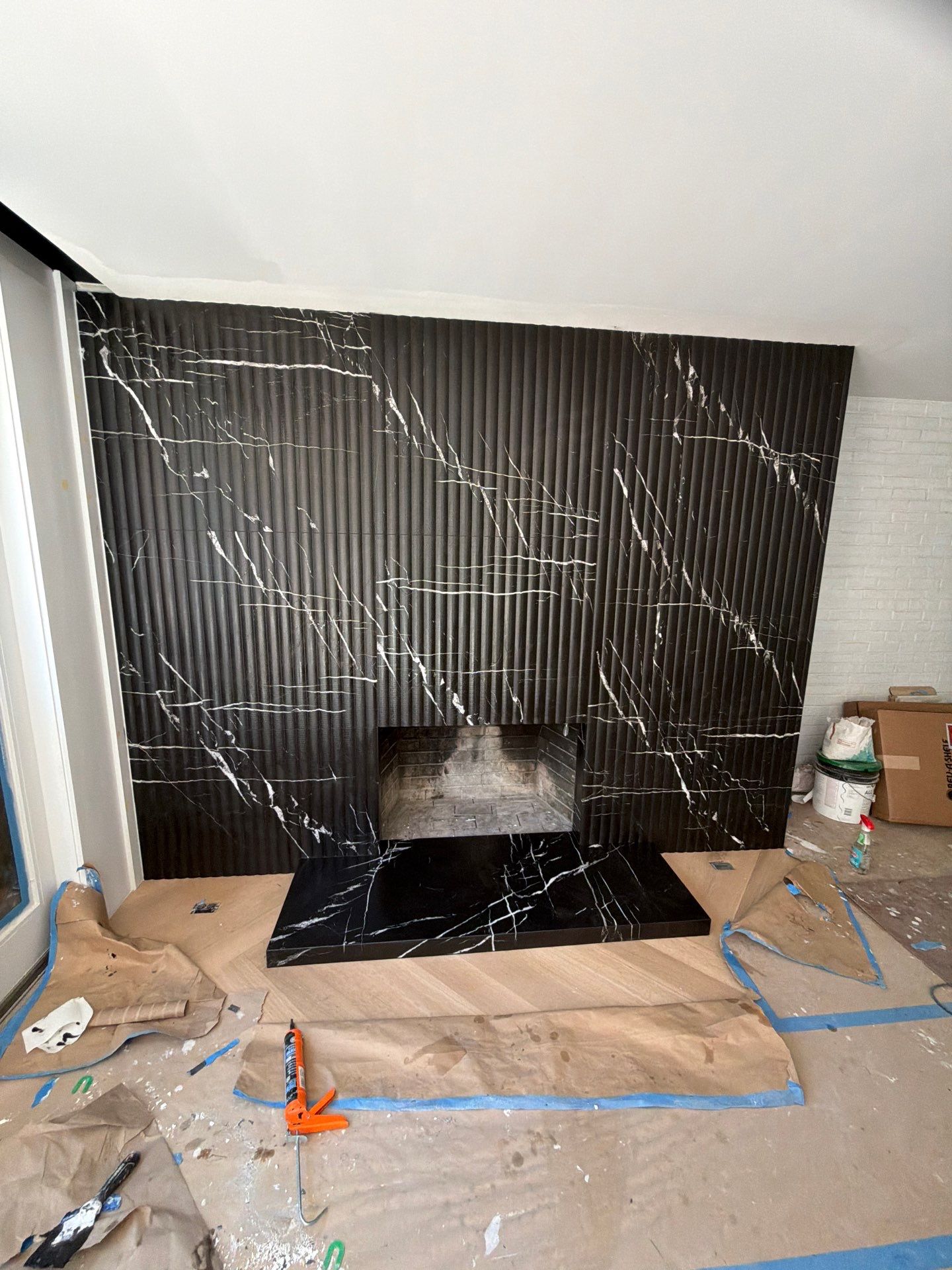 Full-Height Fluted Marble Fireplace Wall by NC Stone And Tiles
