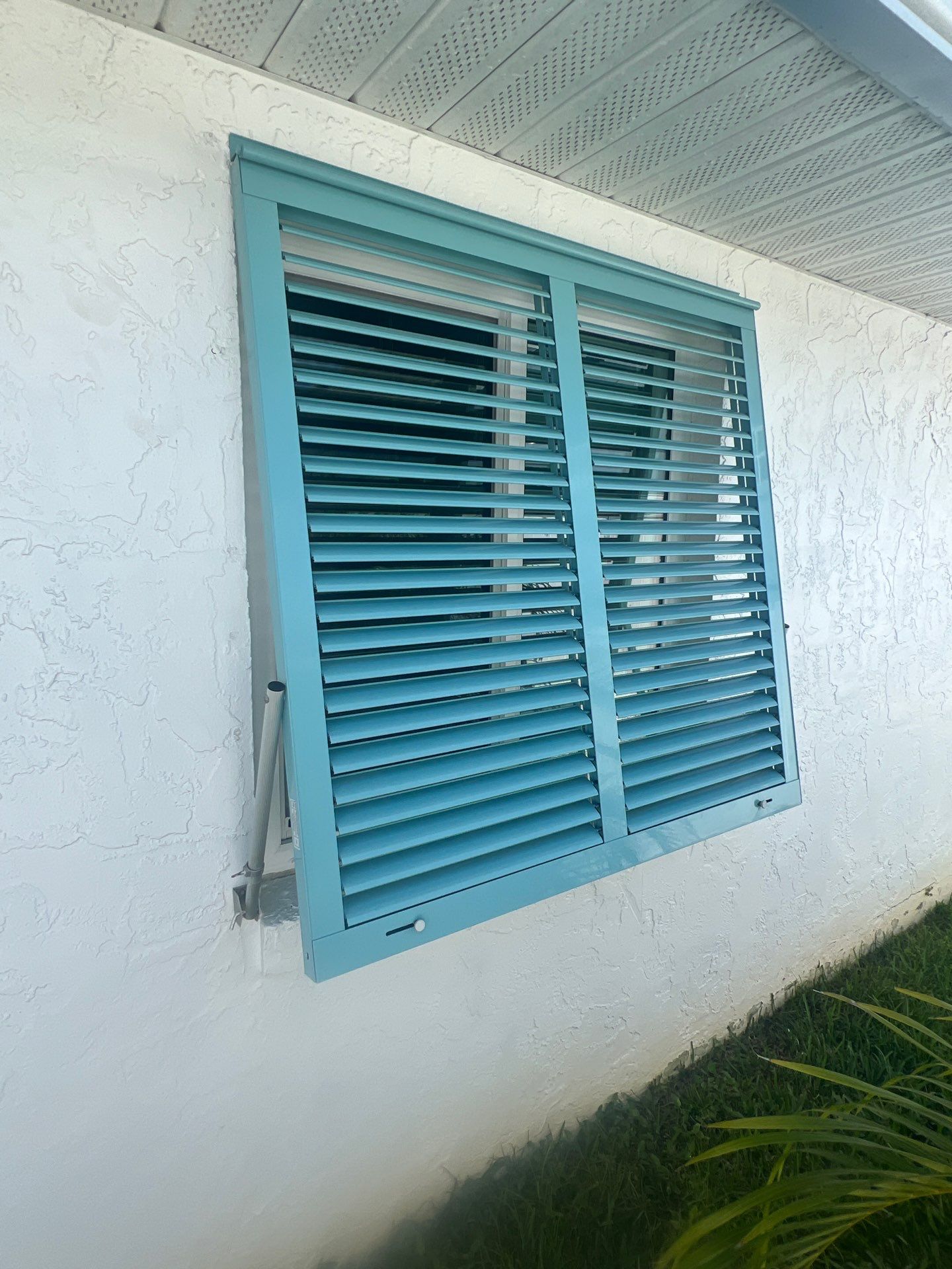 Hurricane Rated Bahama Shutters in Pastel Turquoise  by Smart Guard Shutters