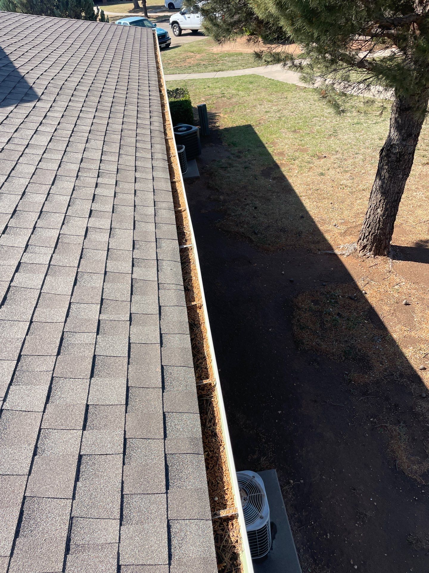 Commercial gutter cleaning Amarillo, TX before photo with filled gutters