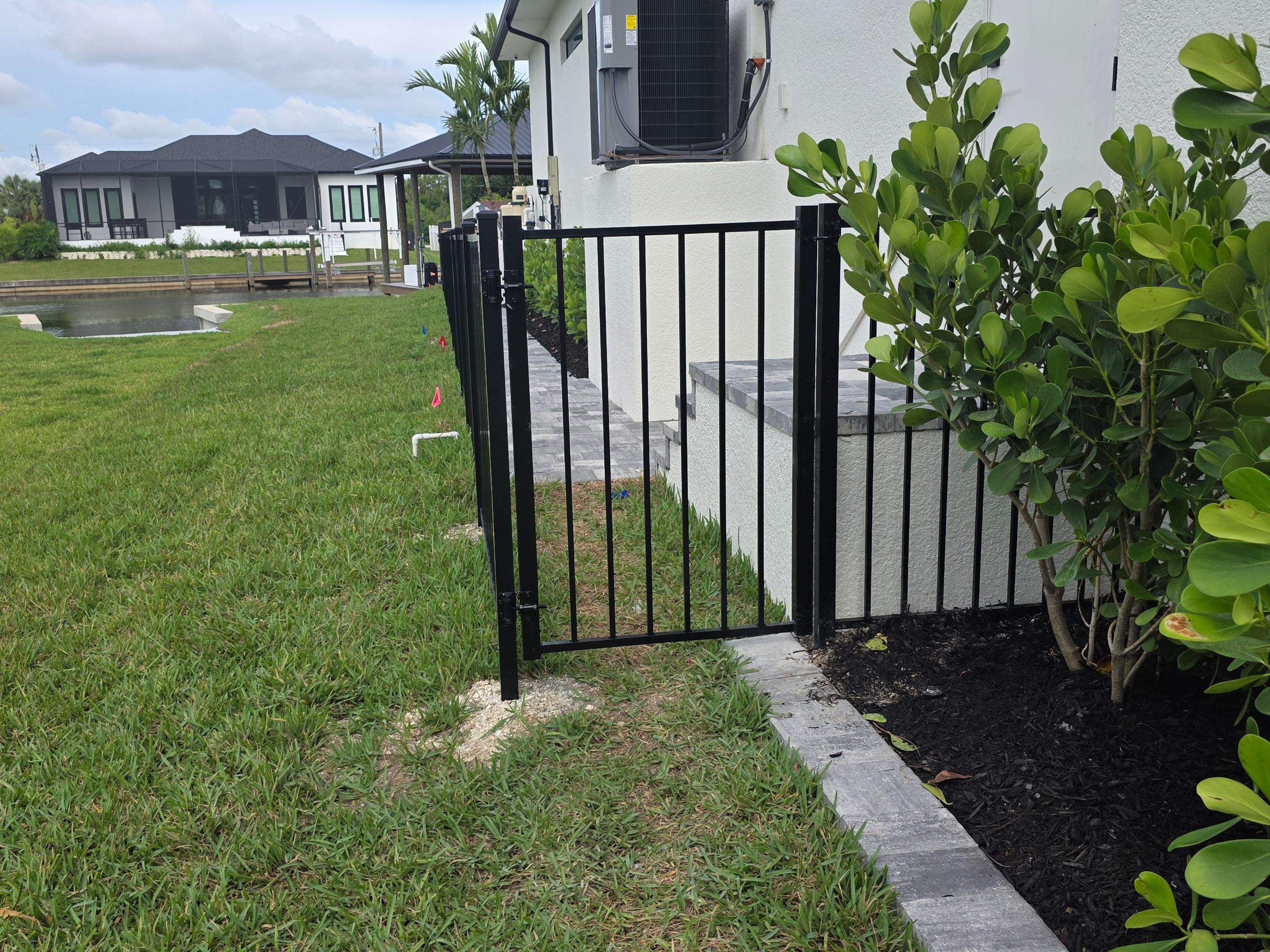 Black Aluminum Fencing and Paver Walkway Installation in Punta Gorda by True Fence LLC