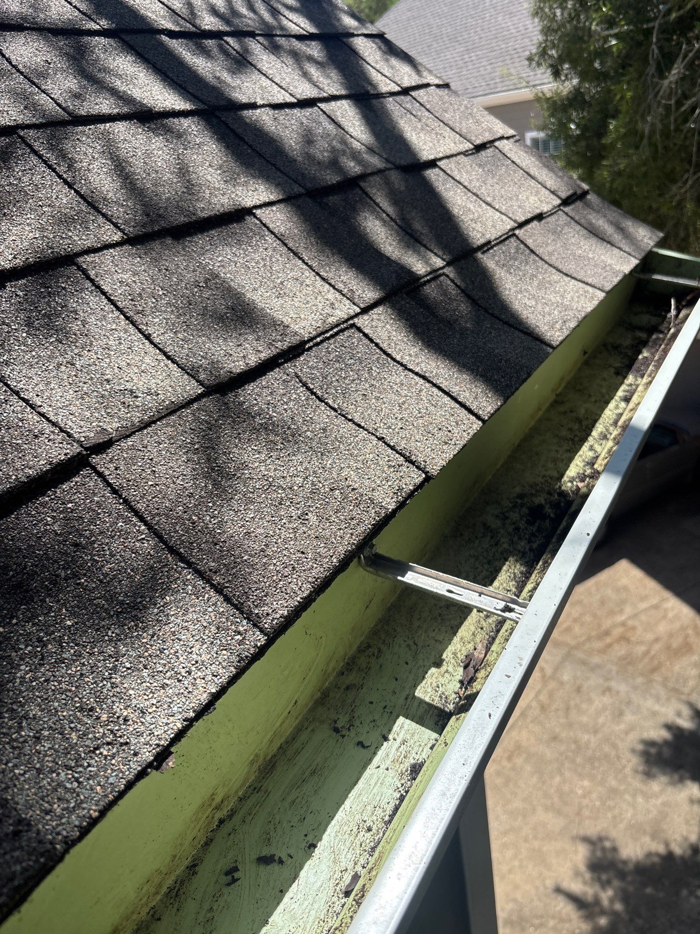 HOA gutter cleaning in Pearland, TX, after  photo showing full gutters.