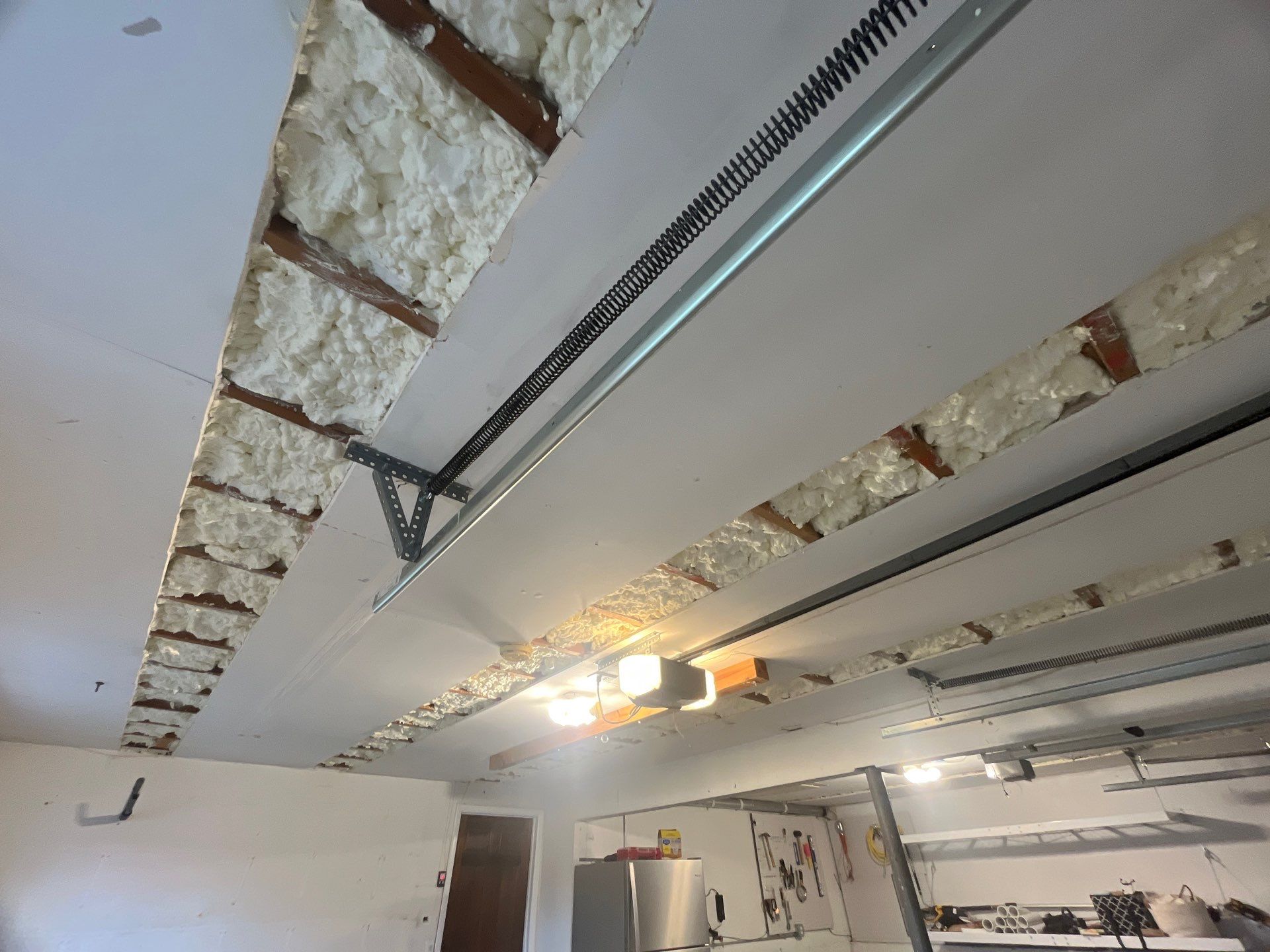 Garage ceiling using open cell spray foam by NYS Foam & Energy