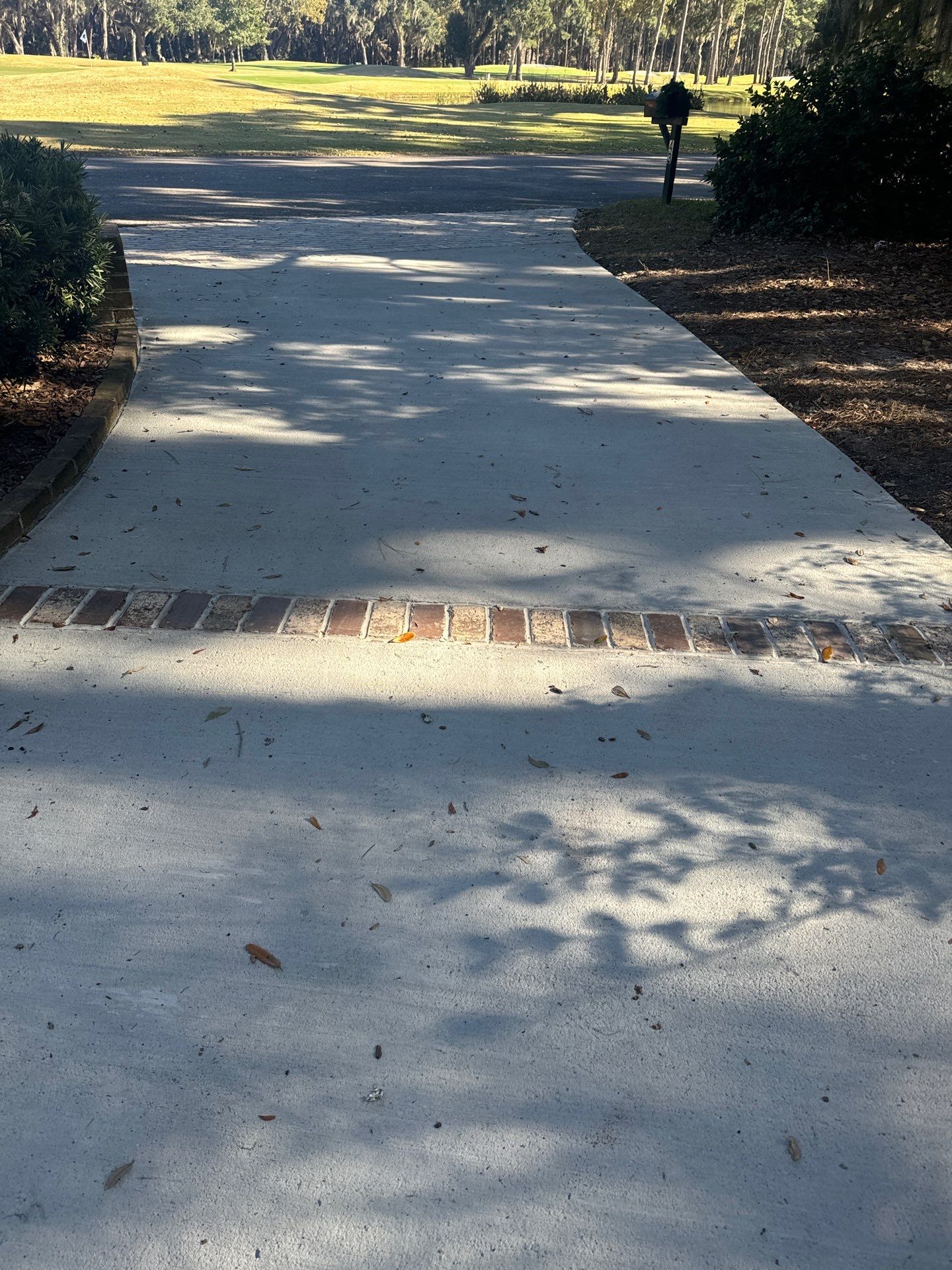 Custom Concrete Driveway Installation with Decorative Brick Borders in Okatie by Lowcountry Scapes, LLC