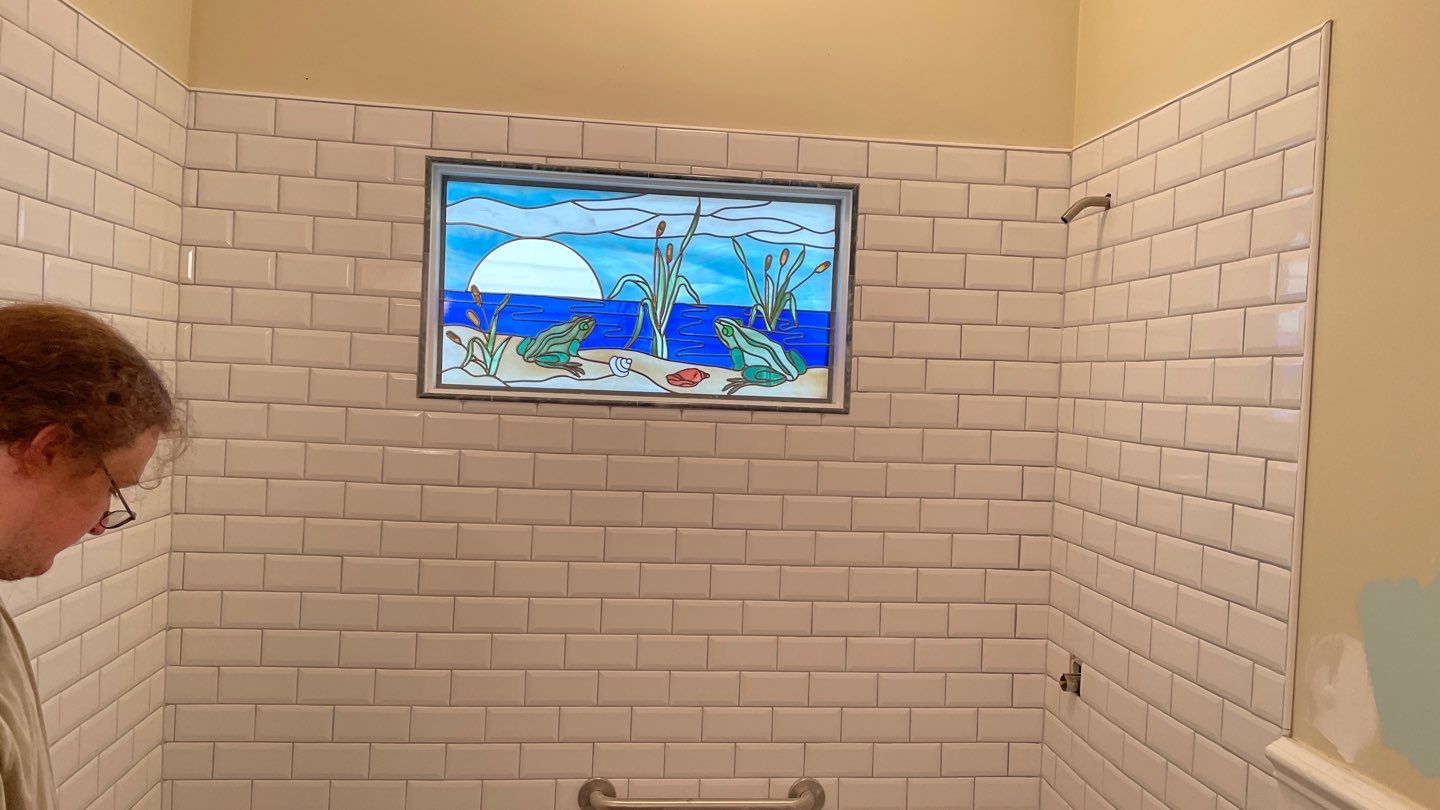 Shower Transition Highlighting Stained Glass Window by Footprints Floors of Coastal Carolina
