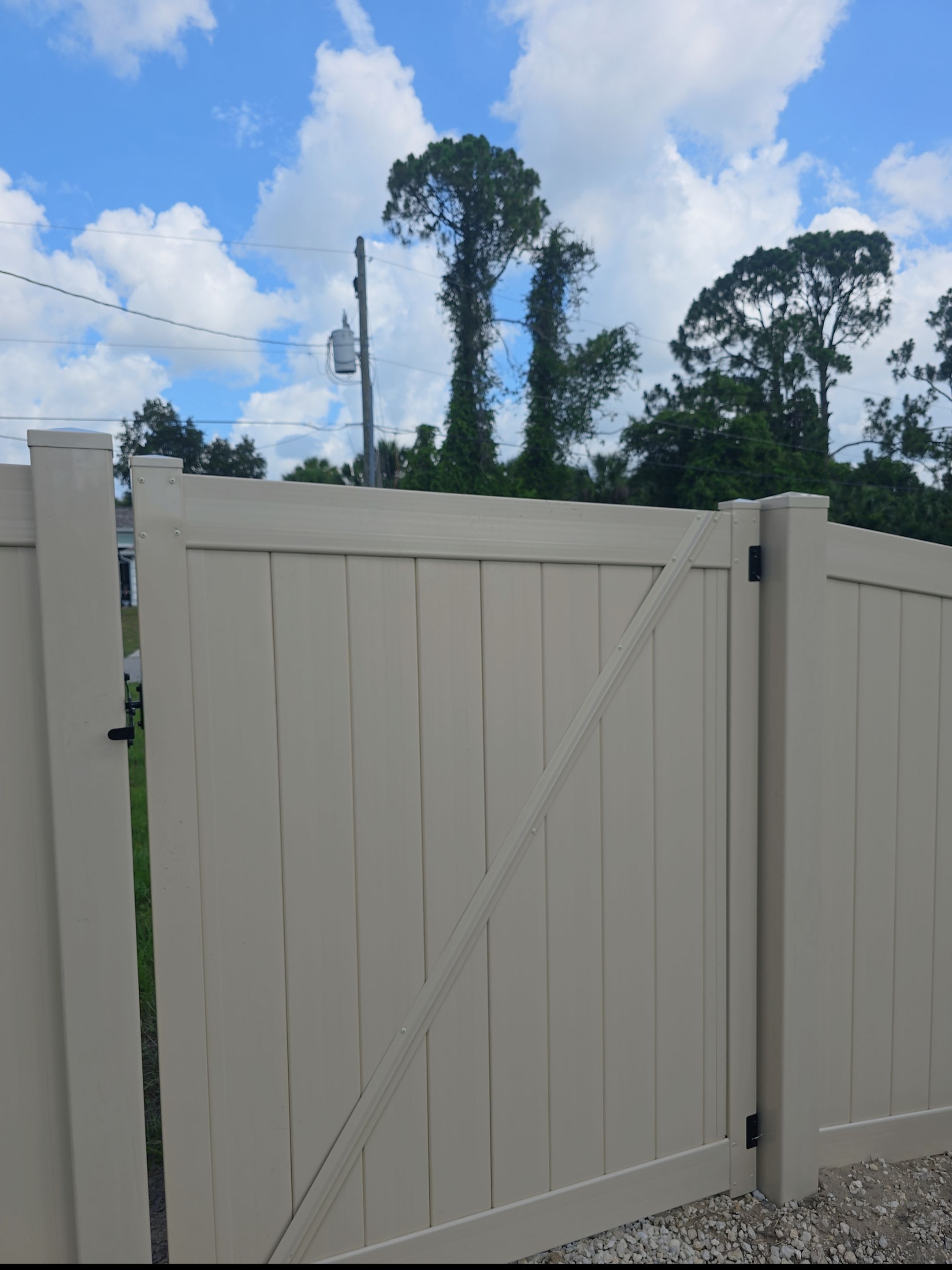 Tan Vinyl Privacy Fence and Gate Installation in North Port by True Fence LLC