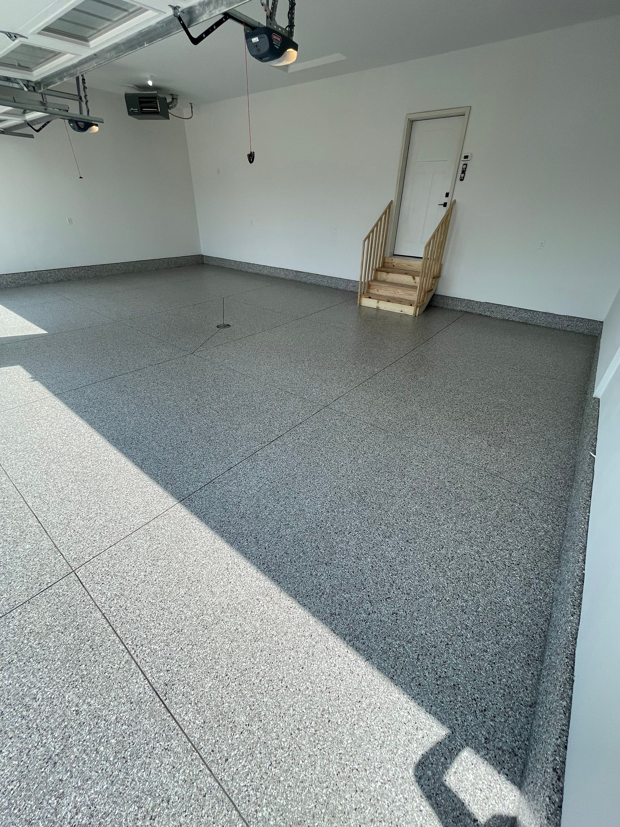 Grey Speckled Garage Floor Coating in Sioux Falls by Select Painting, Coatings & Garage Cabinets