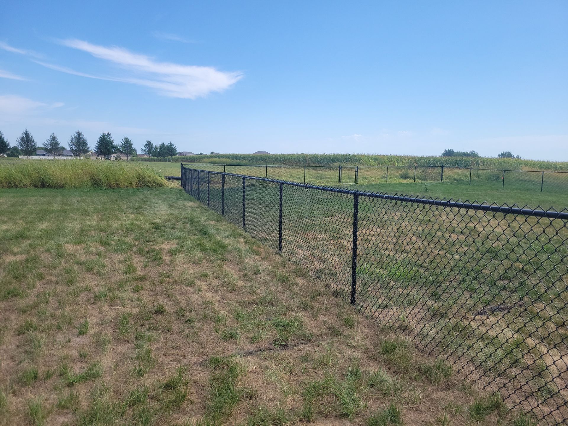 Residential Black Chain Link Fence Installation in Jesup by Perfect Picket Fence and Stain