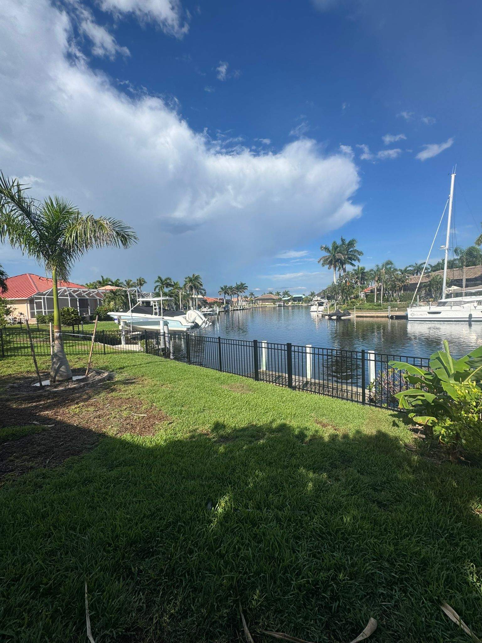Black Aluminum Fence Installation Along Punta Gorda Canal by True Fence LLC