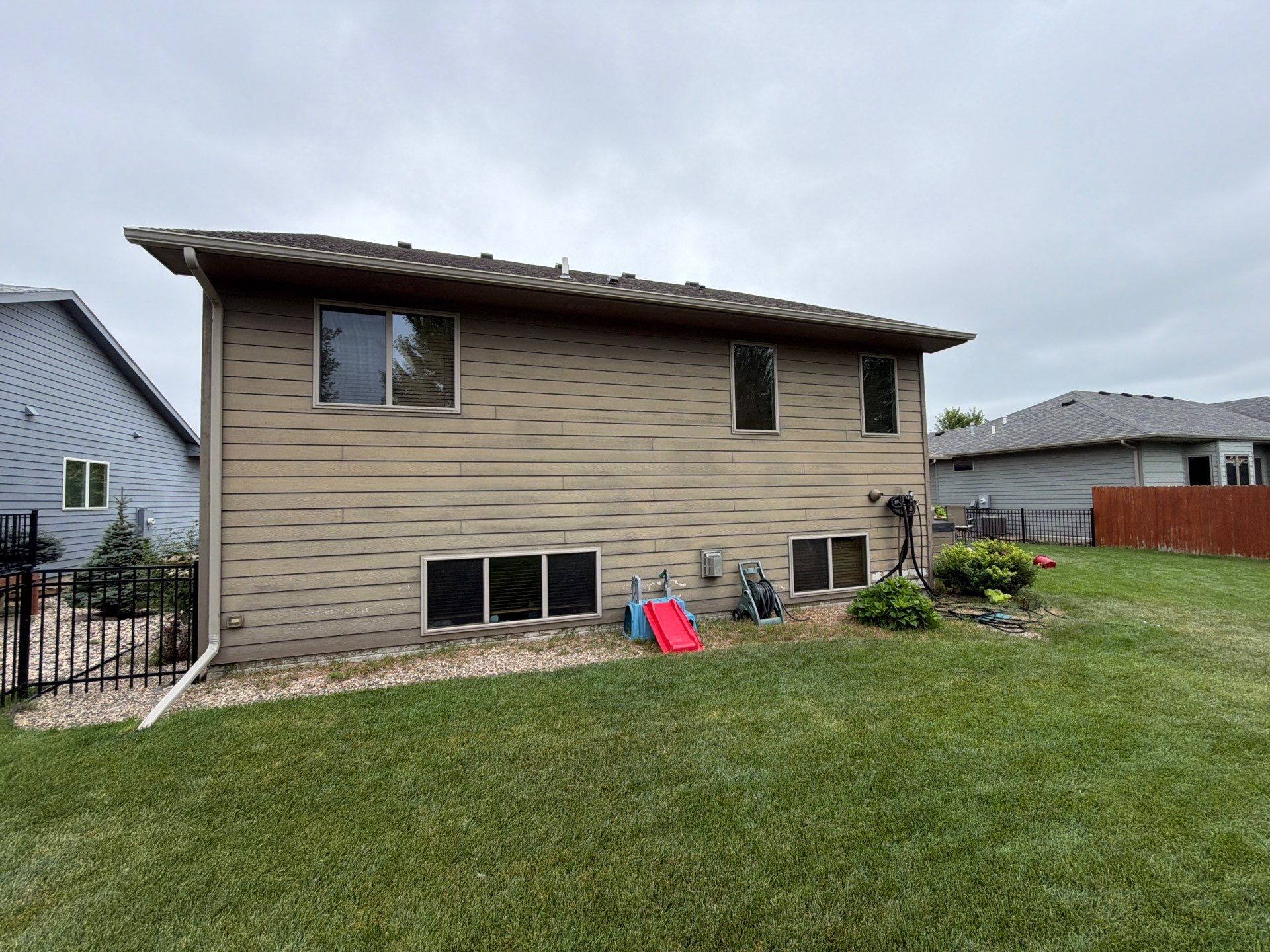 Full Exterior Siding Repaint for Sioux Falls Home and Garage by Select Painting, Coatings & Garage Cabinets