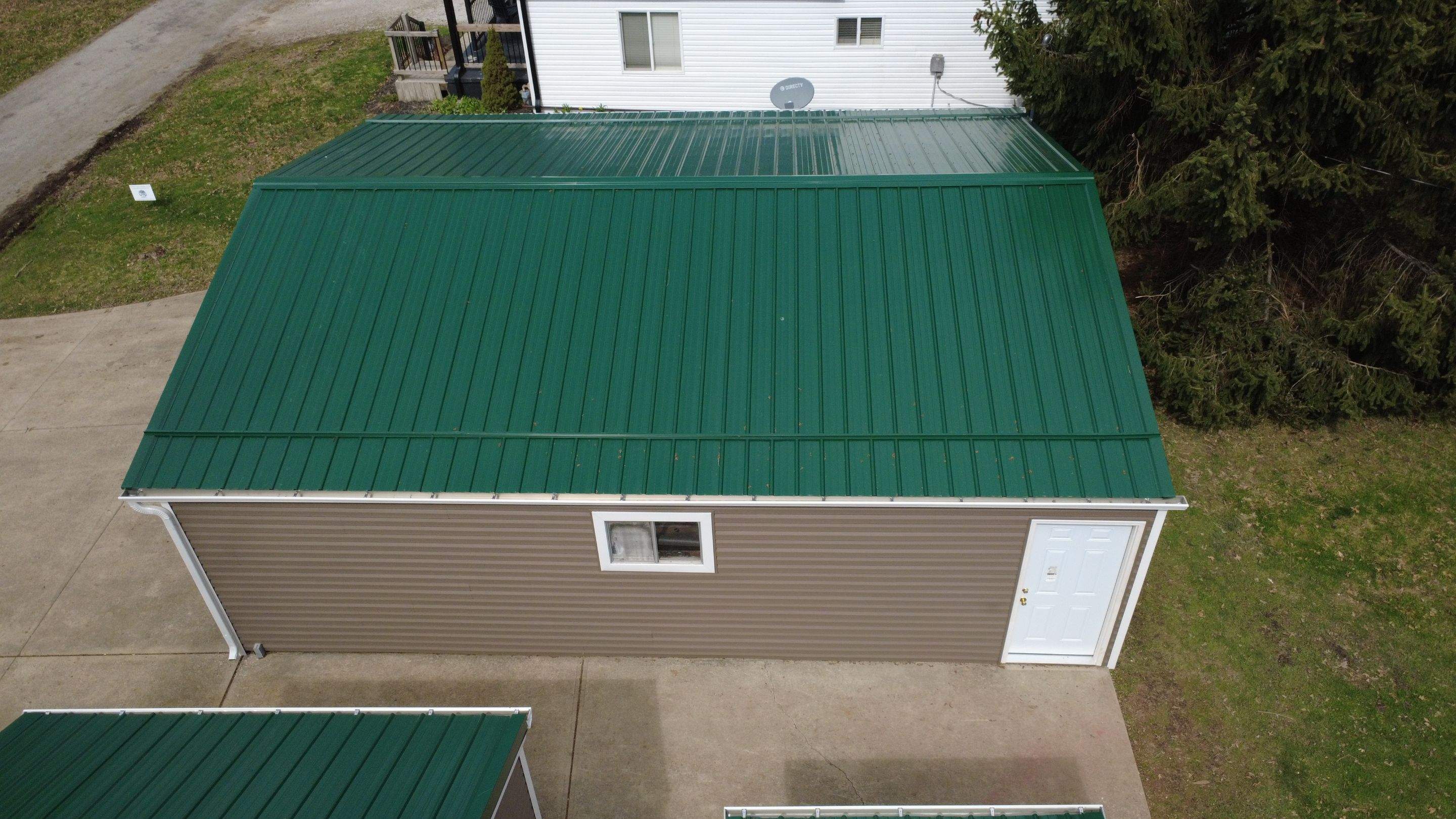 Green Metal Roof Installation and Exterior Renovation in Thornville by Canopy Contracting