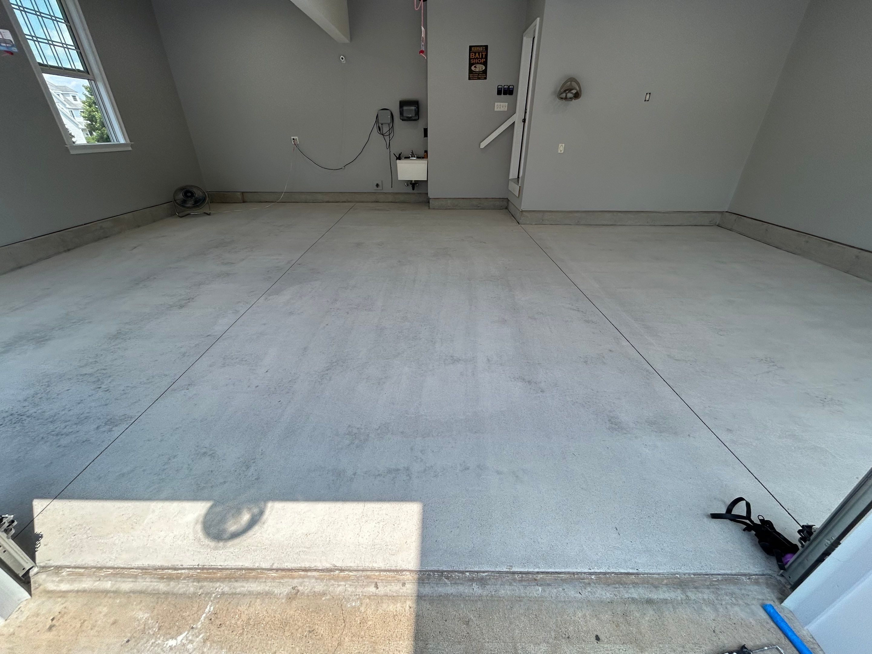 Concrete Floor Coating Transformation by DiGiorgi Roofing and Siding Inc