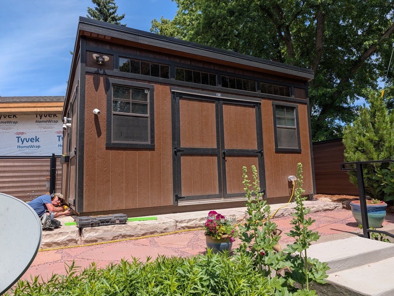 Modern Shed Construction with Stone Foundation in Sioux Falls by Select Painting, Coatings & Garage Cabinets
