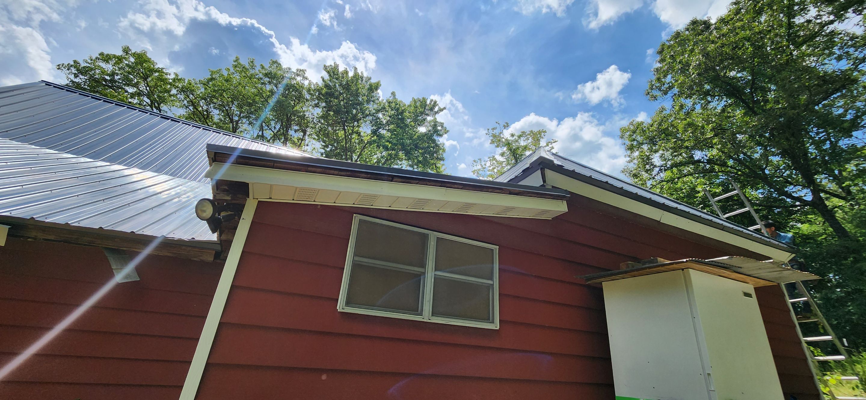 Residential Roofing Installation using 26 Gauge Colored Panels by Hostetler Roofing