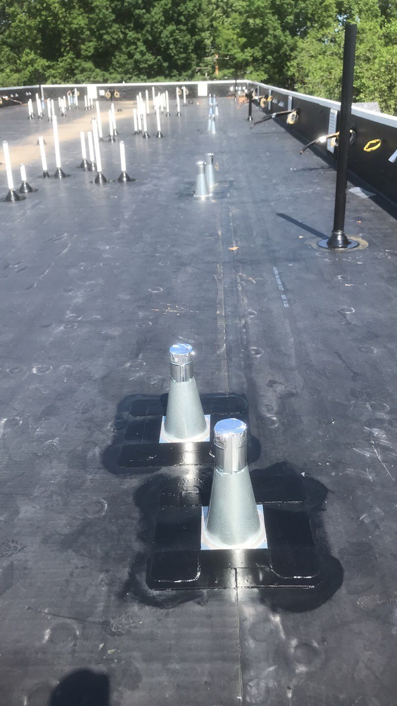 Commercial Roofing Installation using EPDM with white gutters by A Plus Exterior