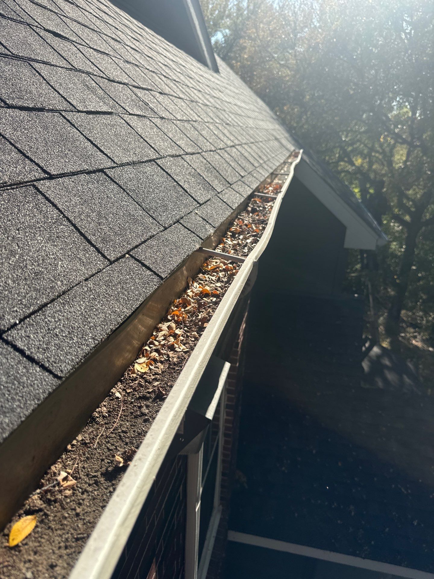 HOA gutter cleaning in Pinehurst & Southern Pines, NC,before  photo showing full gutters.