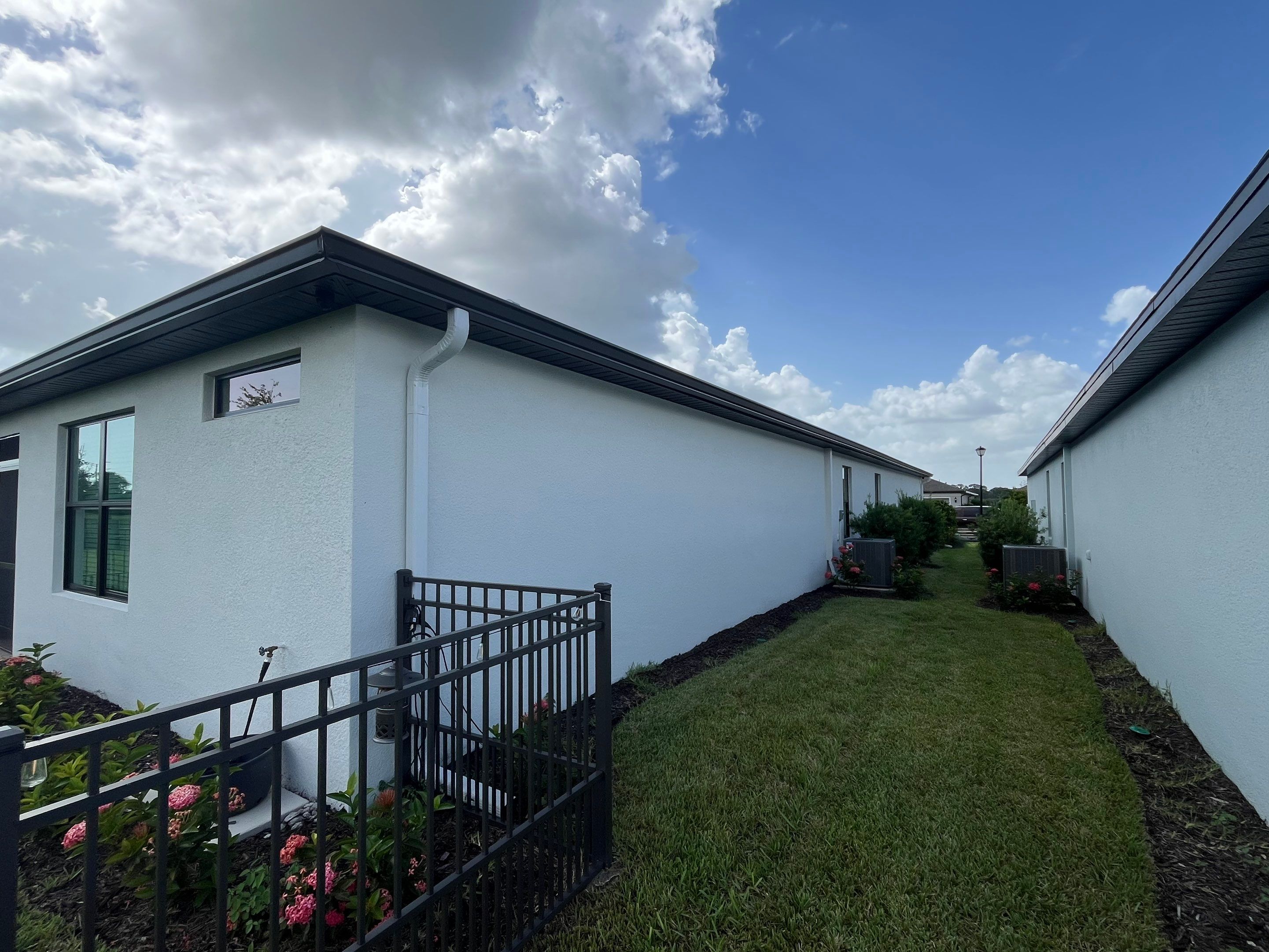 Dark Bronze Gutters and White Downspouts in Sarasota FL by Gutter Professors